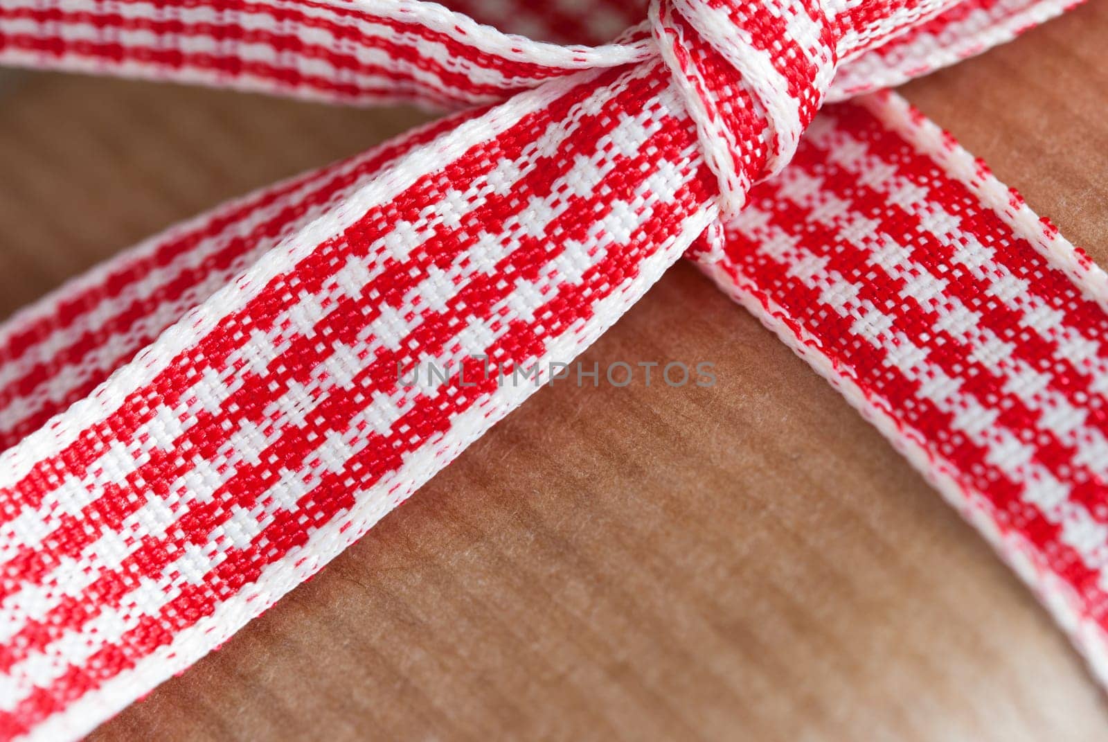 Closeup of a Red White Gift Ribbon on a Brown Present