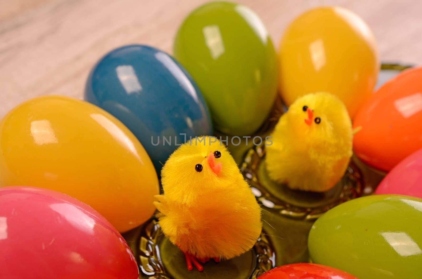 Colorful Easter eggs on a green ceramic plate