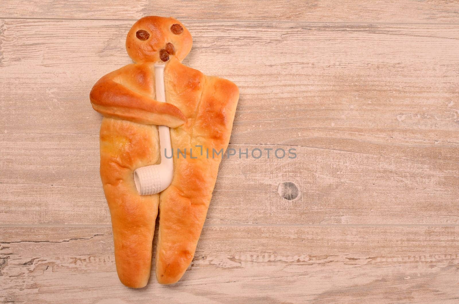 Raising bread man on a rustic wooden background