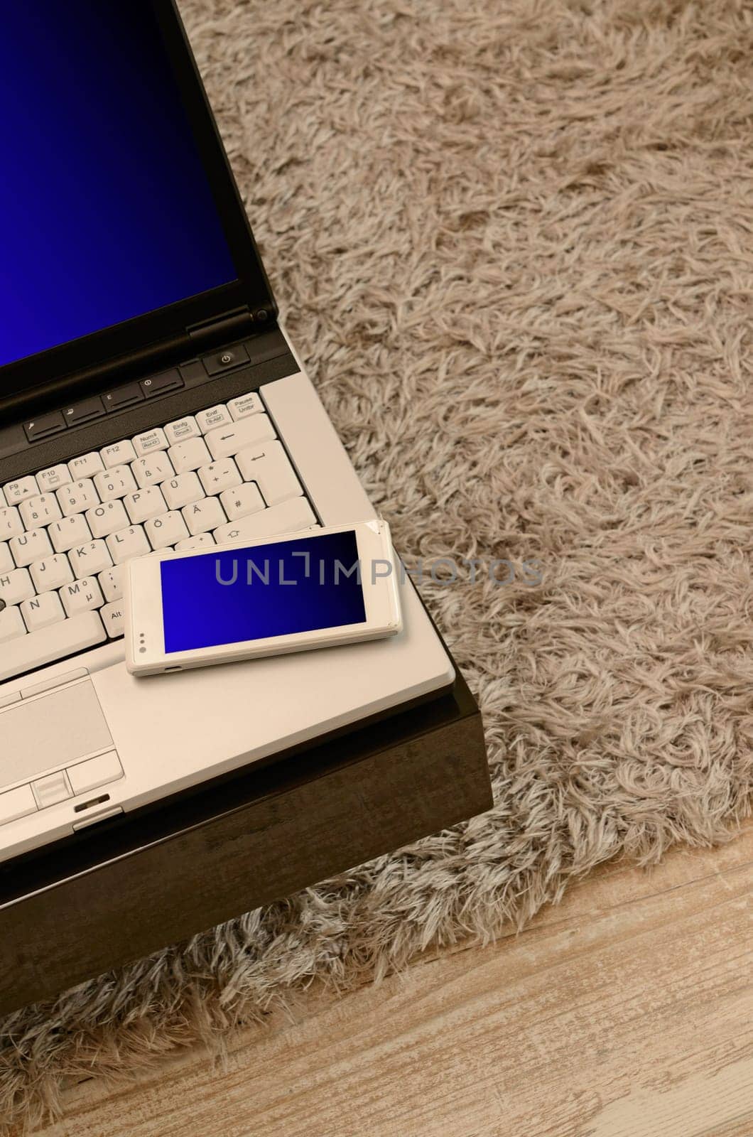 Notebook with a cellphone on a modern table in a living room