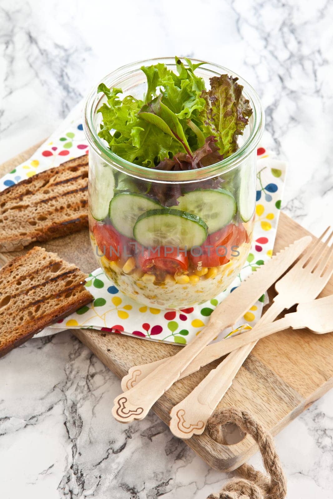Layered salad with fresh mud in the mason jar