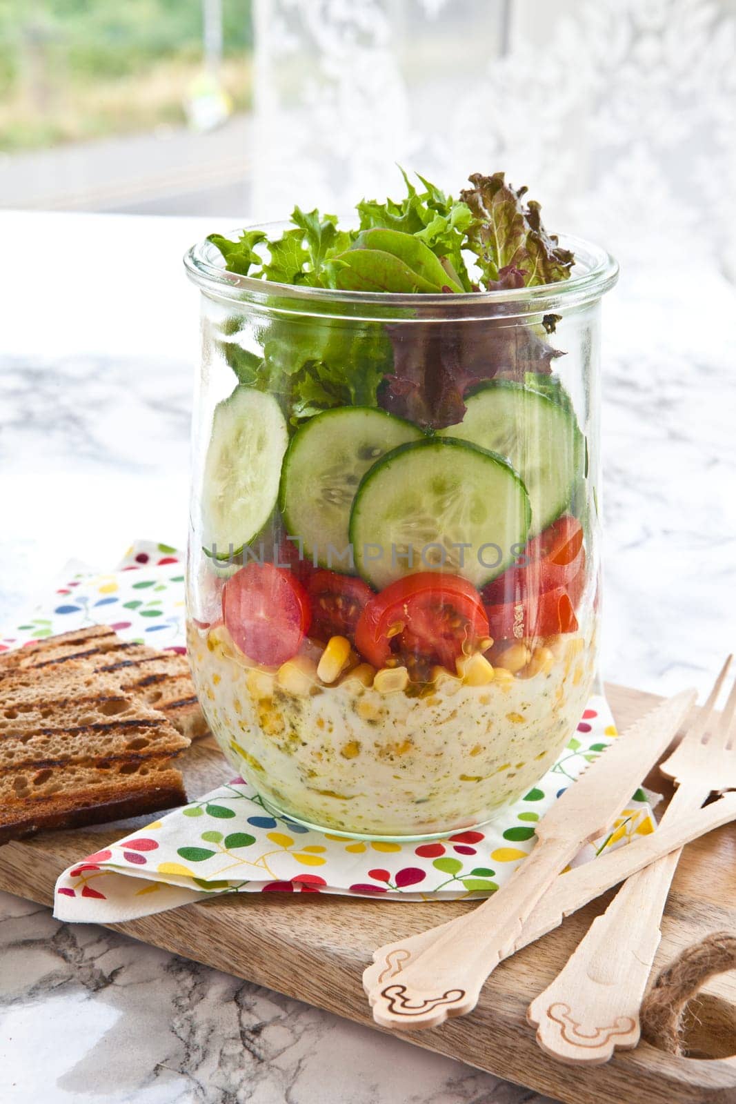 Layered salad with fresh mud in the mason jar