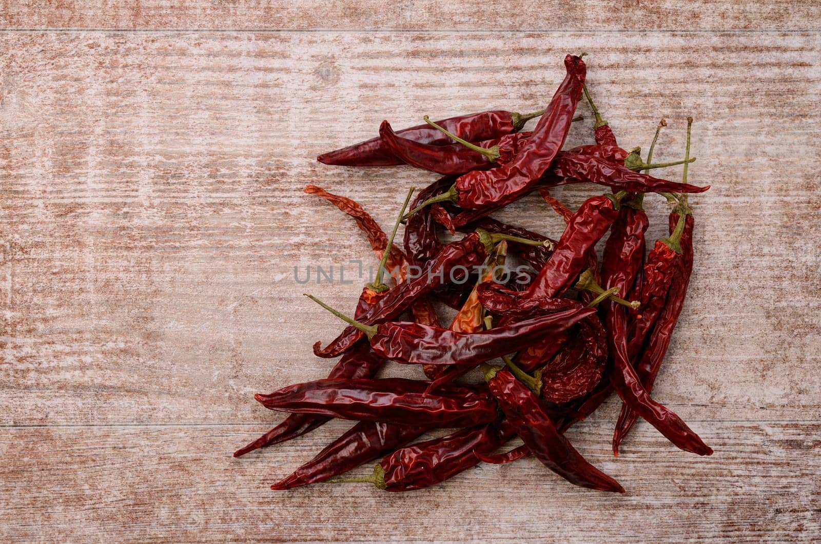 Dried chilies on a rustic wooden background