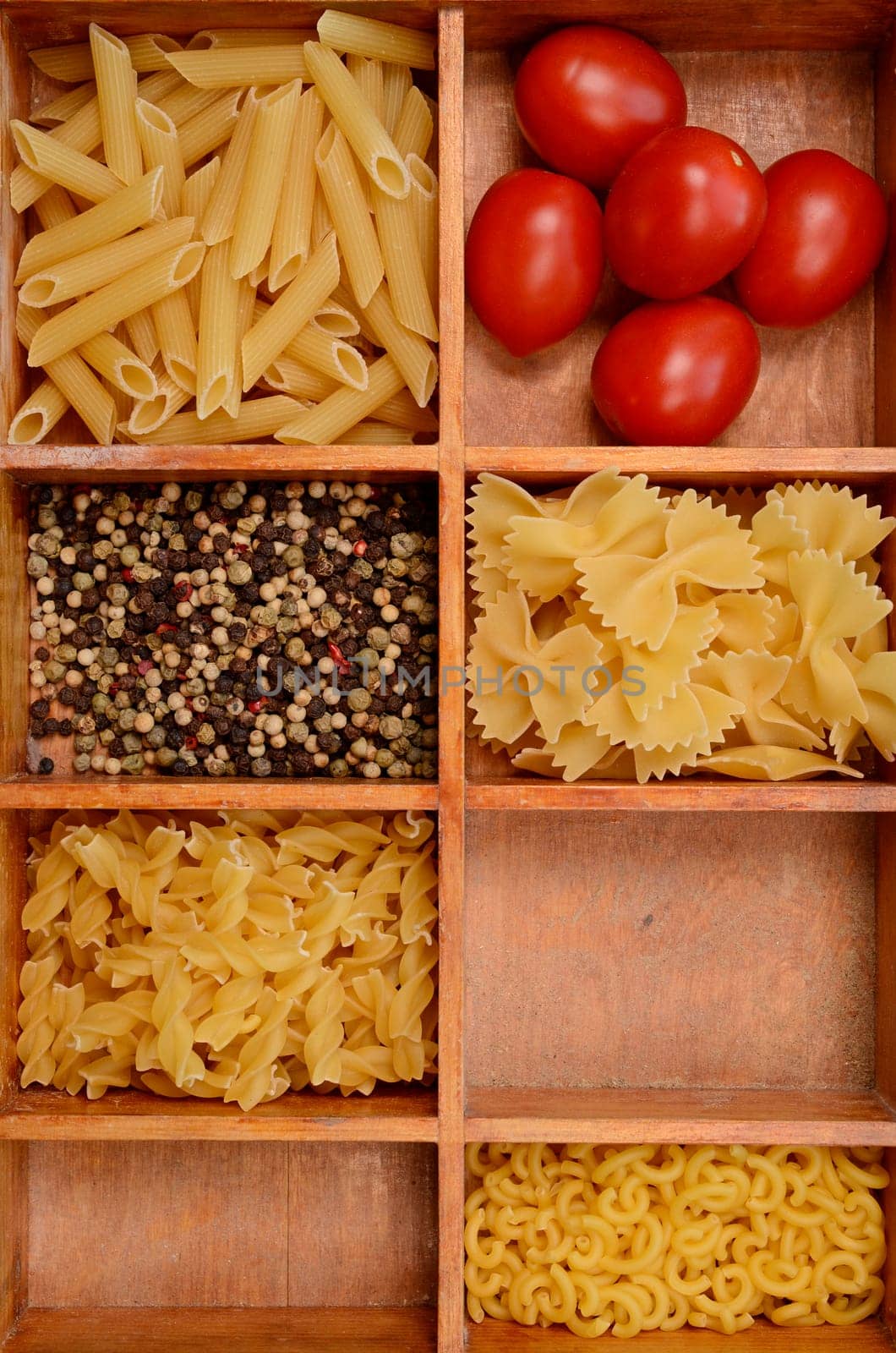 Old wooden box with pasta ingredients