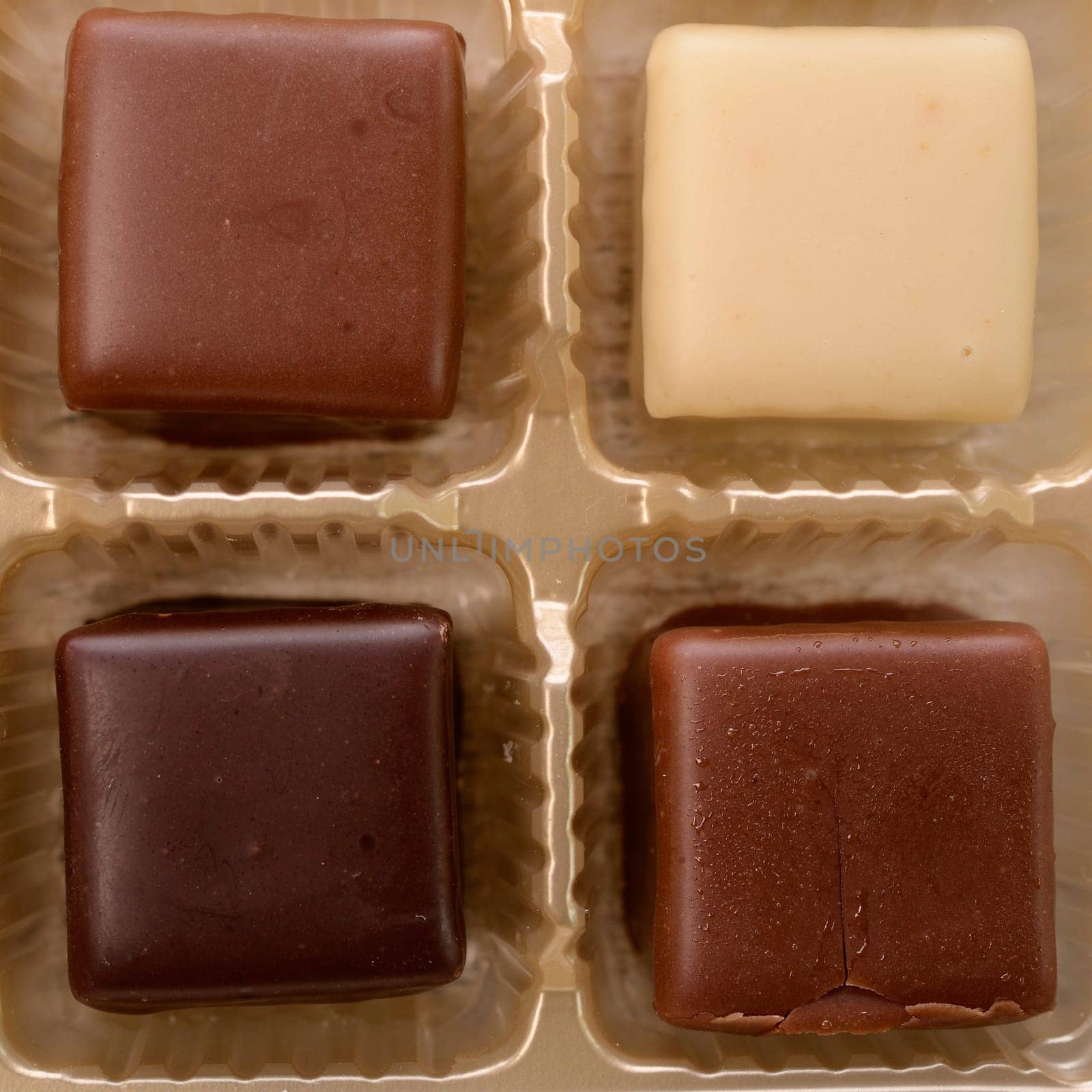 Sweet chocolate dices in a box ,top view