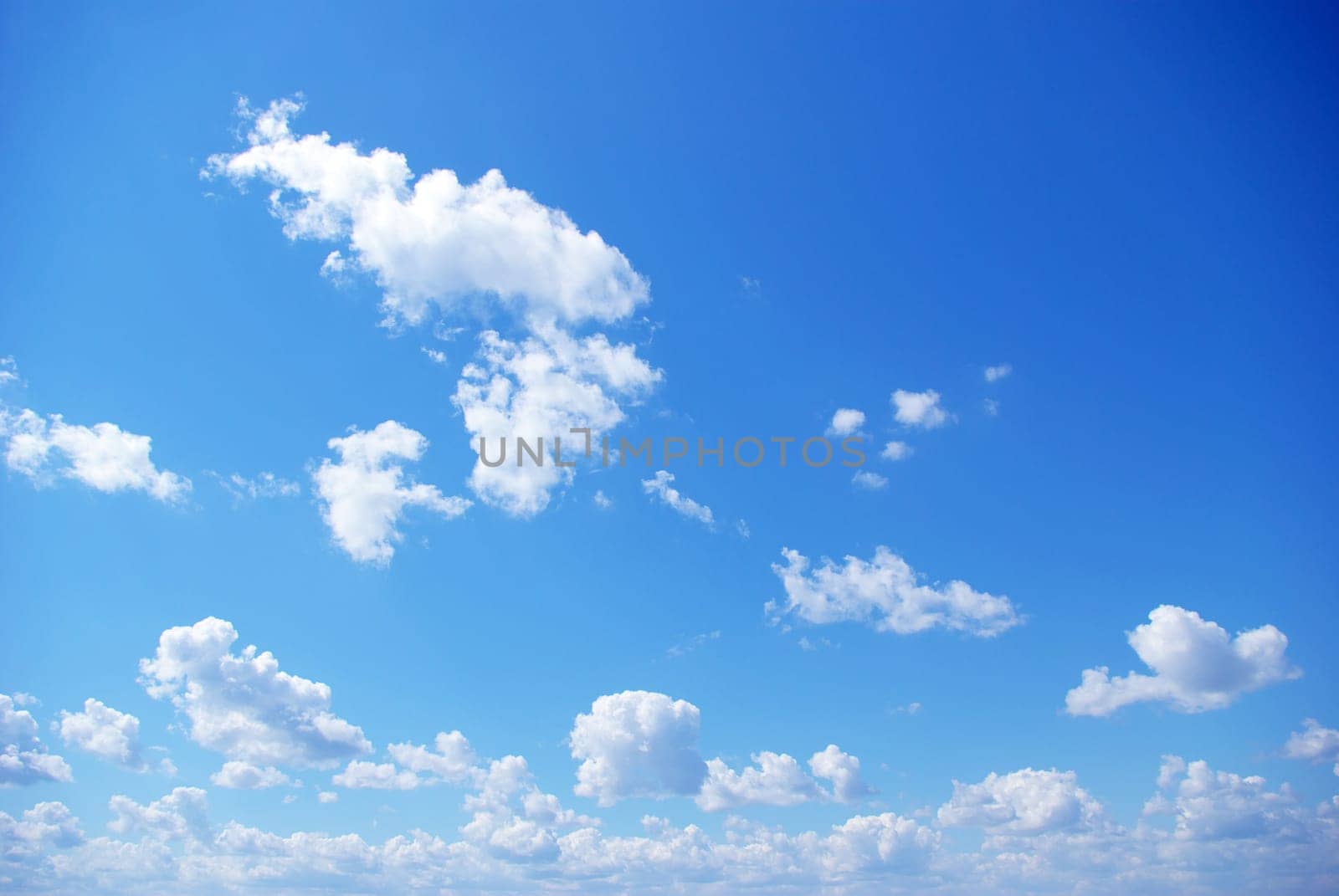 Blue sky background with a tiny clouds