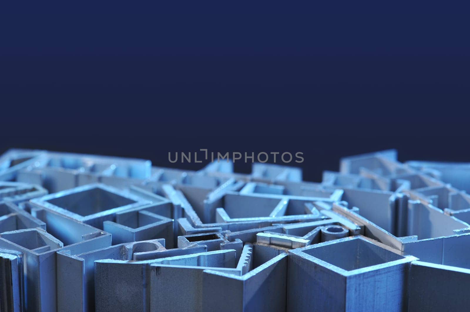many different aluminium profile strips in blue spotlight