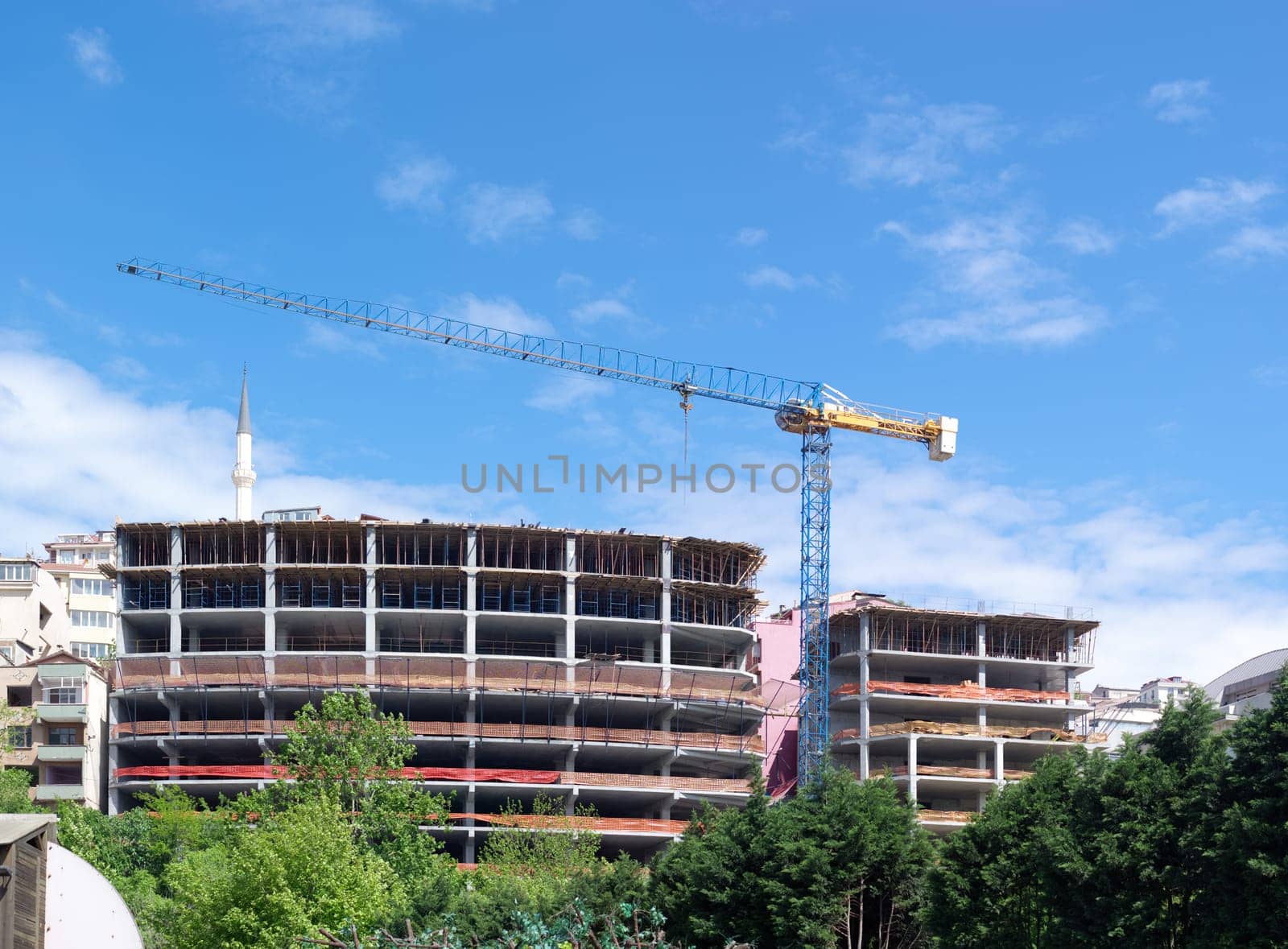 high-rise building with a crane on a construction site