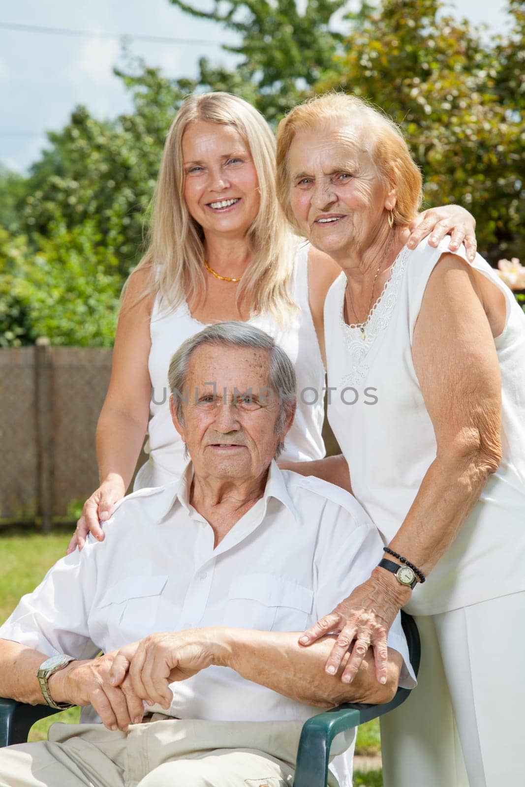 Elderly couple and their daughter outdoors
