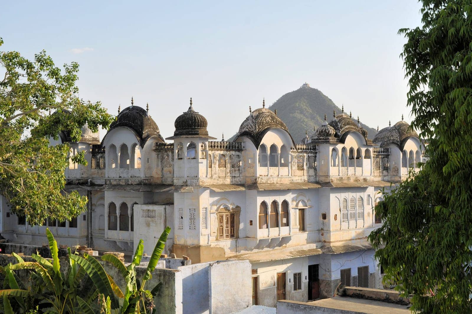 Typical traditional architecture in the holy Hindu city of Pushkar, Rajasthan, India with mountain temple in bakcground