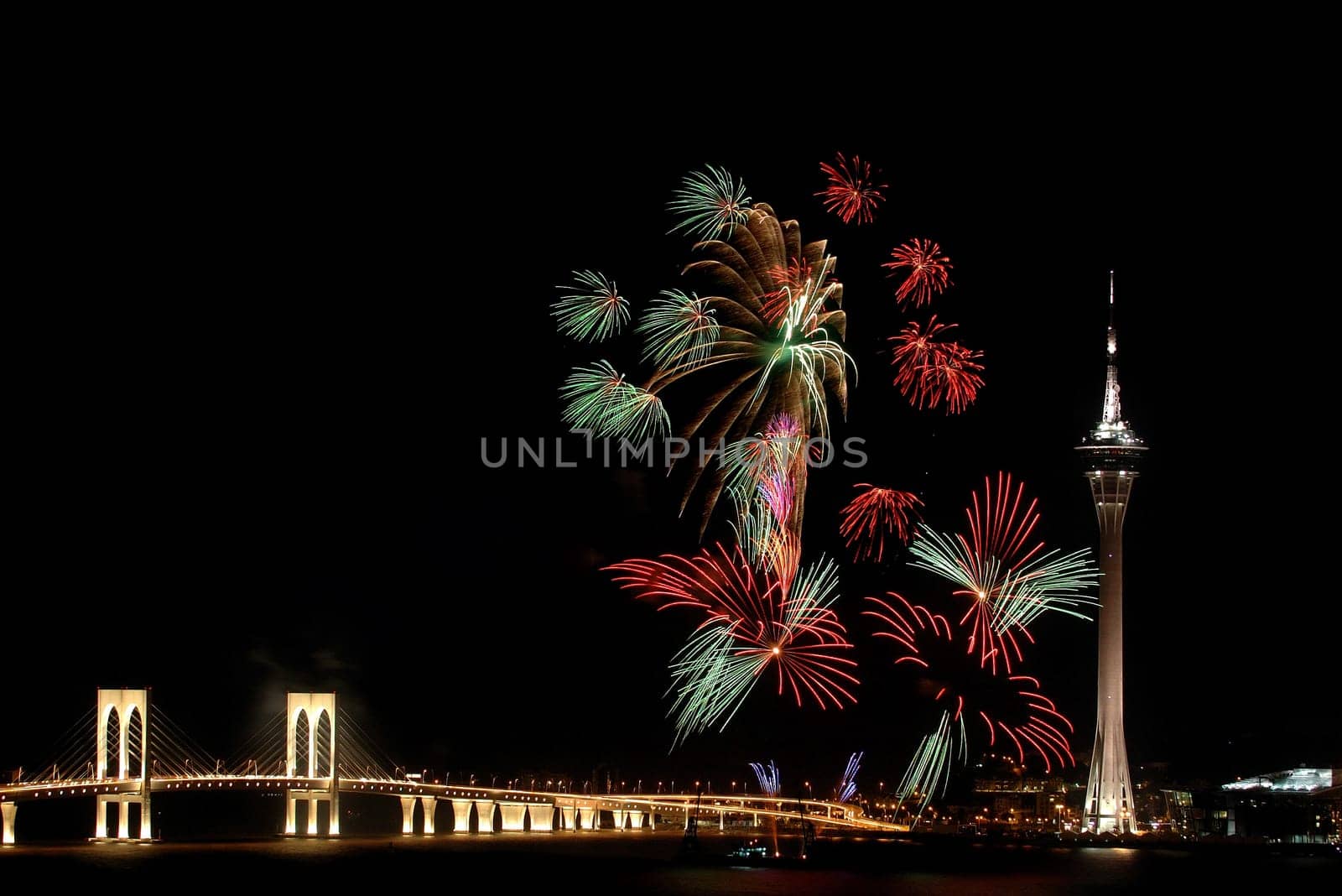 Celebration of New Year in Macau with fireworks beside the Tower Convention and Sai Van bridge