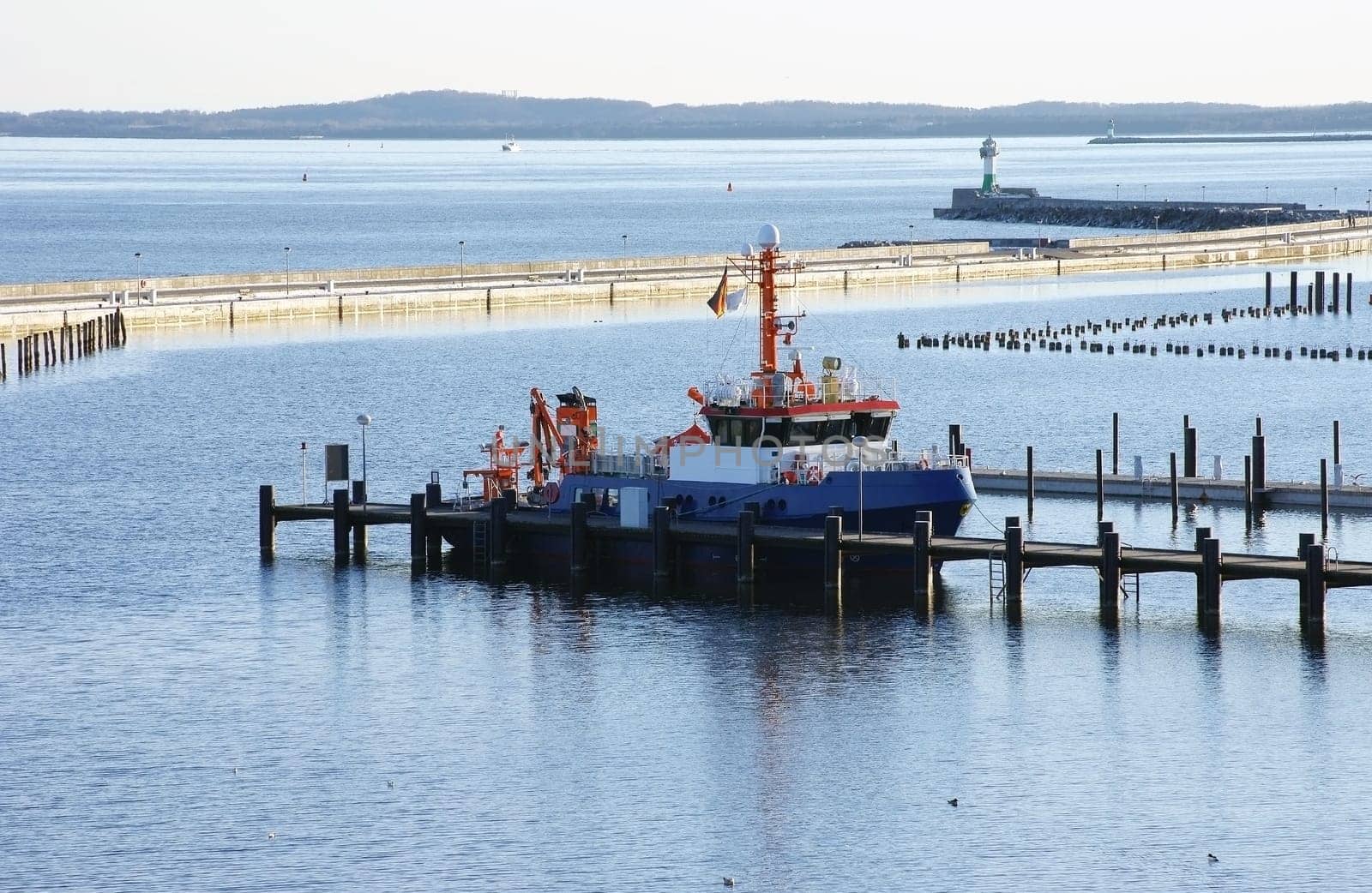 A photograph of a fishing boat in a harbour area of the Baltic Sea.