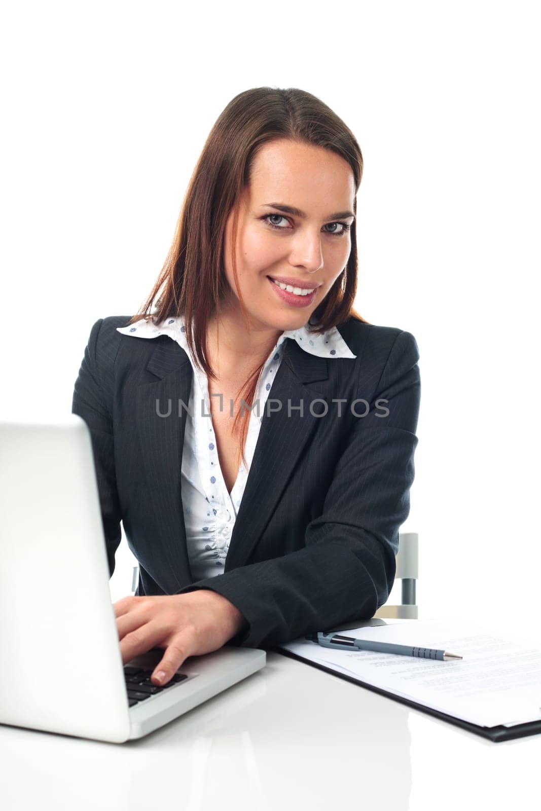Pretty business woman working on laptop, isolated on white