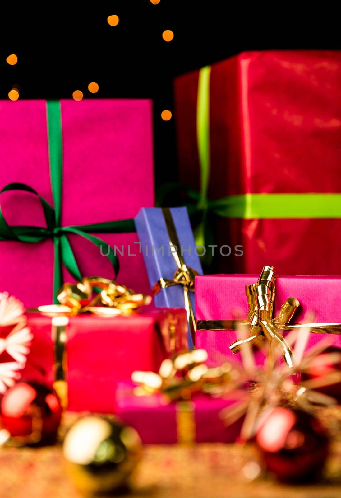 Presents packed in plain papers for Christmas. Narrow depth of field. Focus is on the small magenta gift box with the golden bow on the right..