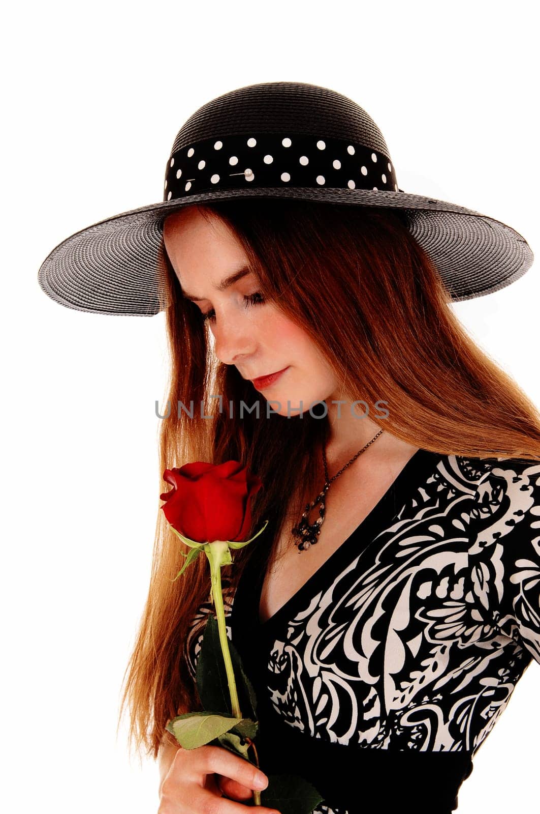 A portrait picture of a pretty woman holding a red rose and wearing a.nice hat, isolated for white background..