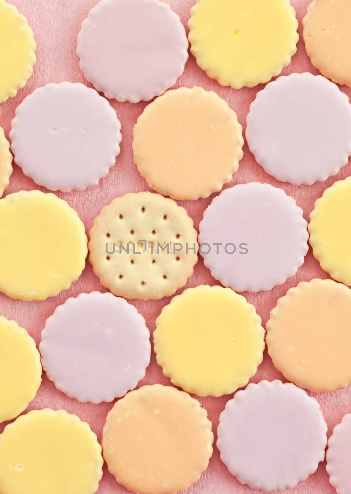 Round biscuits with colorful icing in pastel colours