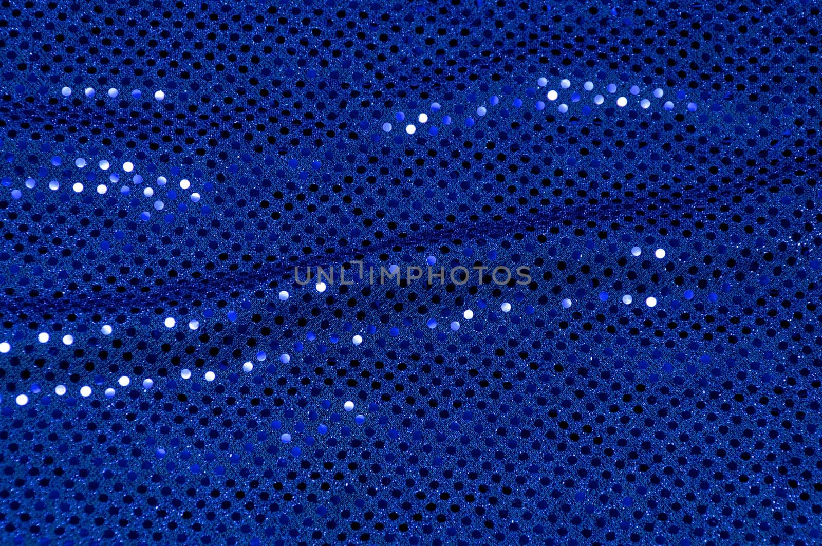 A piece of blue sequined fabric typically used to make dancer's costumes fills the image.