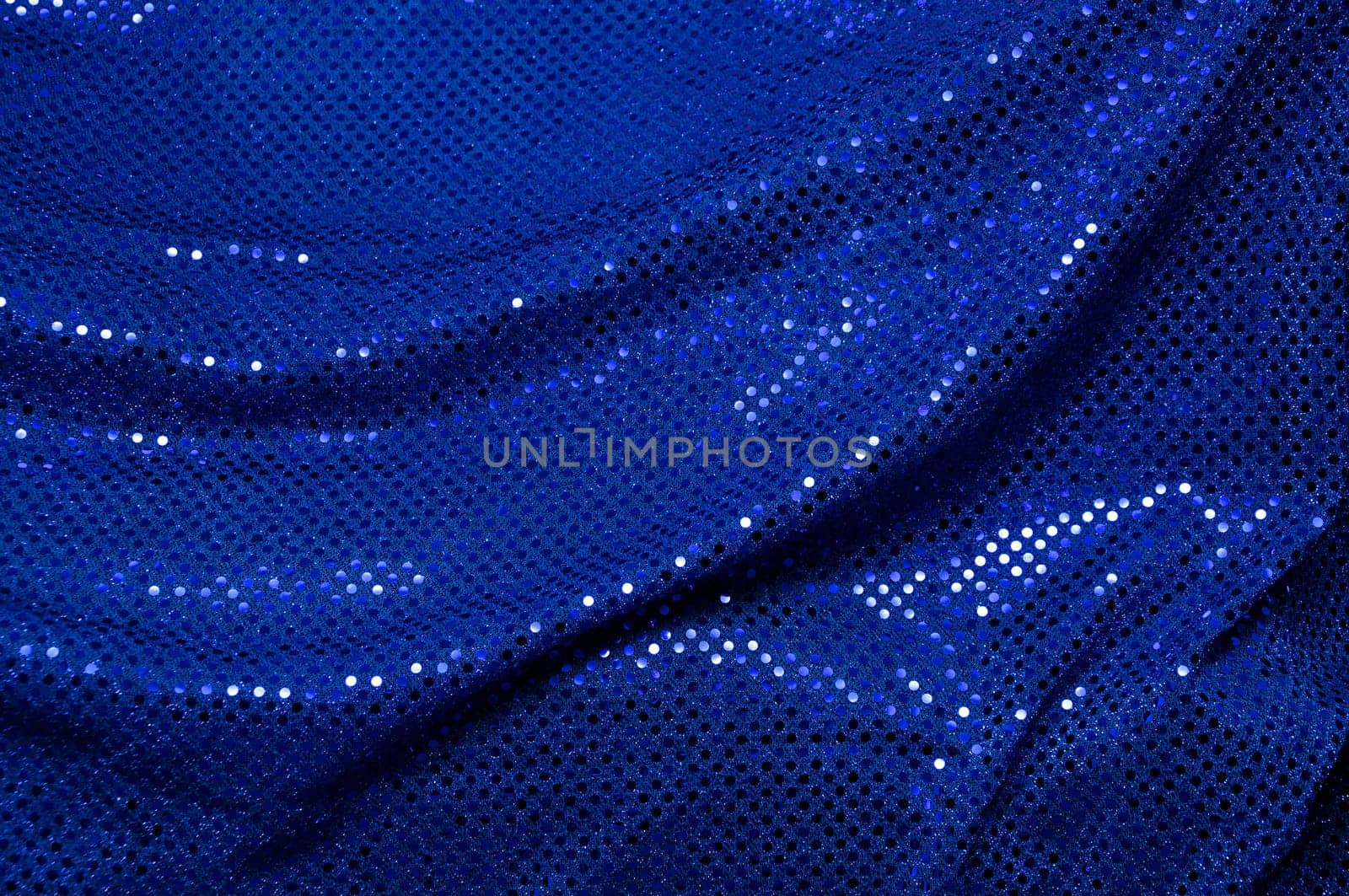 A piece of blue sequined fabric typically used to make dancer's costumes fills the image.
