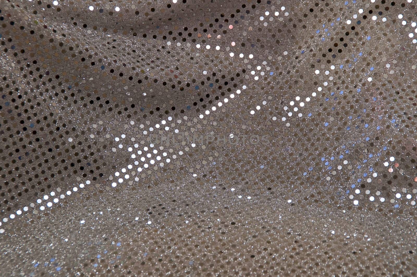 Abstract image of a silver grey sequined piece of fabric typically used to make dancer's costumes or dresses.