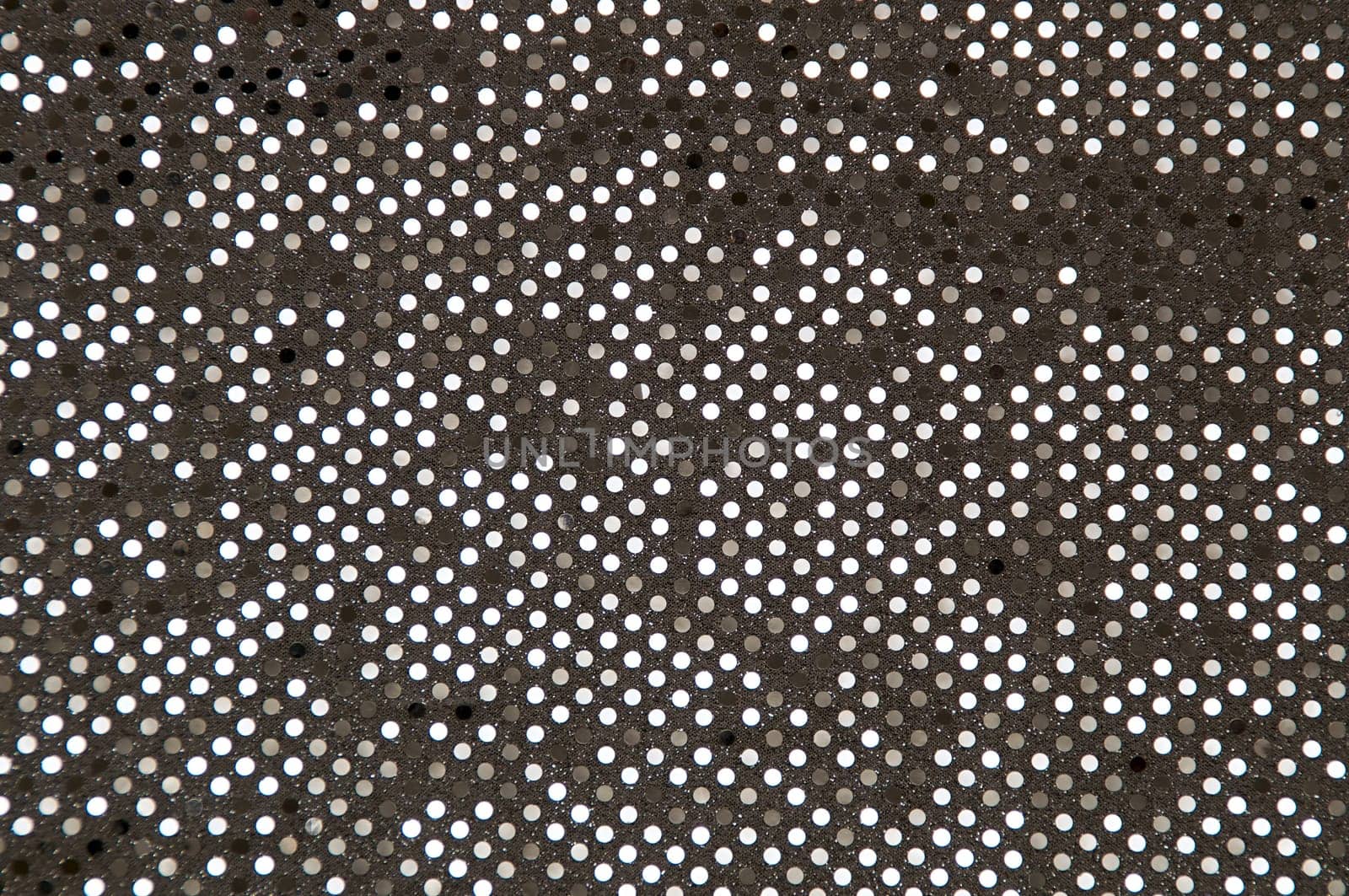 Abstract image of a silver grey sequined piece of fabric typically used to make dancer's costumes or dresses.