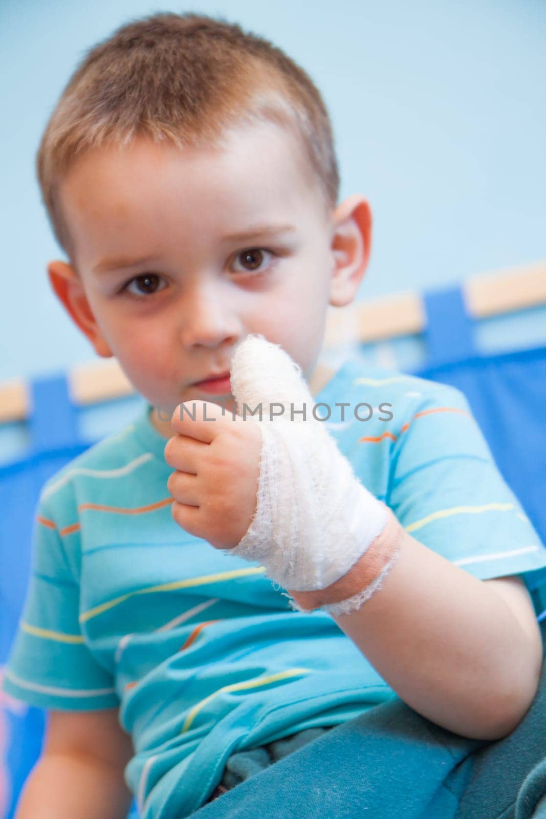 wounded in the left hand with bandage boy at shot in home