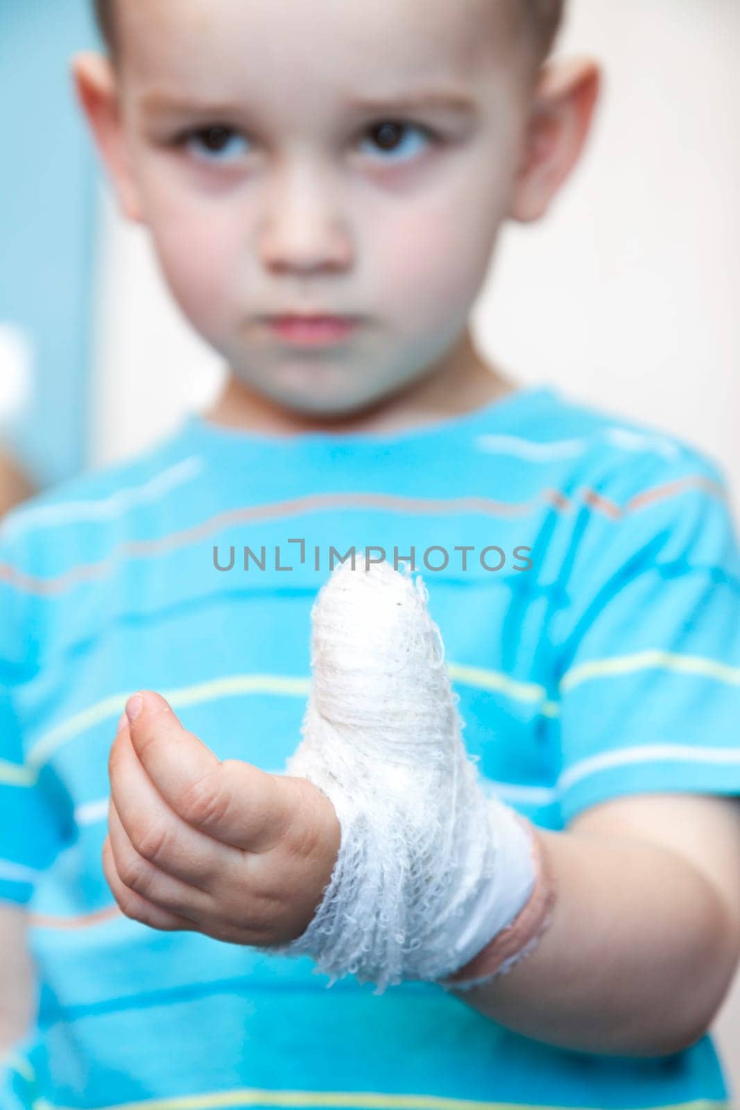 wounded in the left hand with bandage boy at shot in home