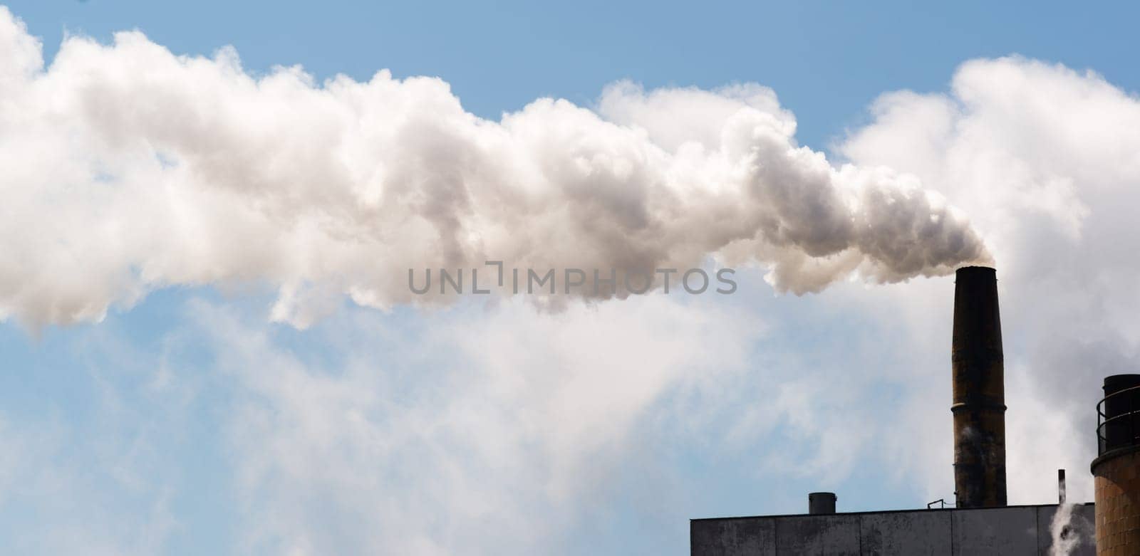 White smoke billows out of industrial stack day in and day out