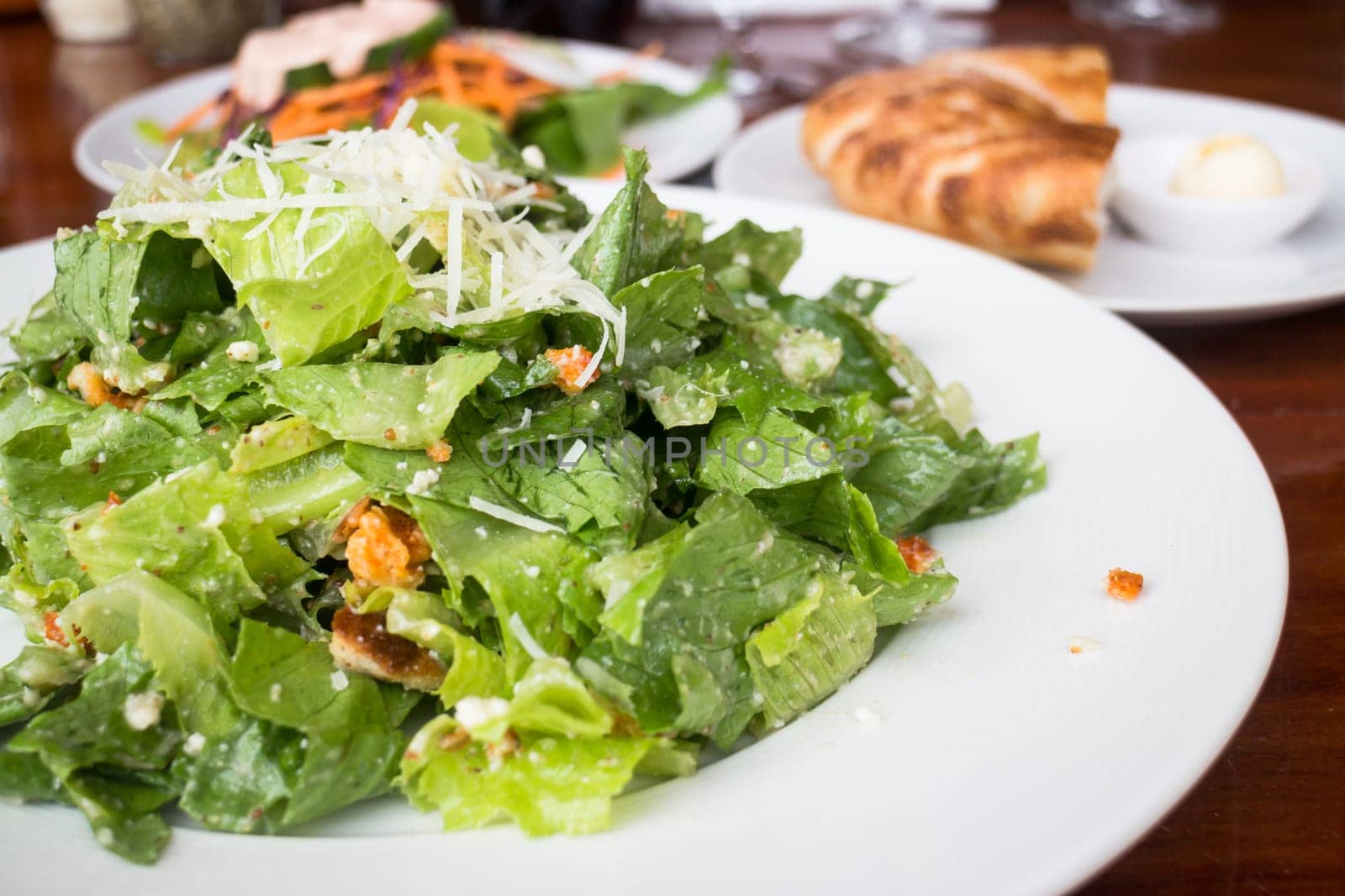 Closed up caesar salad served on wooden table, stock photo