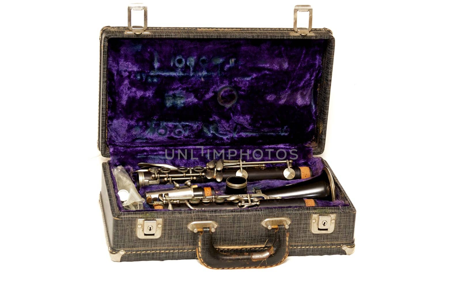 A open clarinet case with locks and handle shot over white.