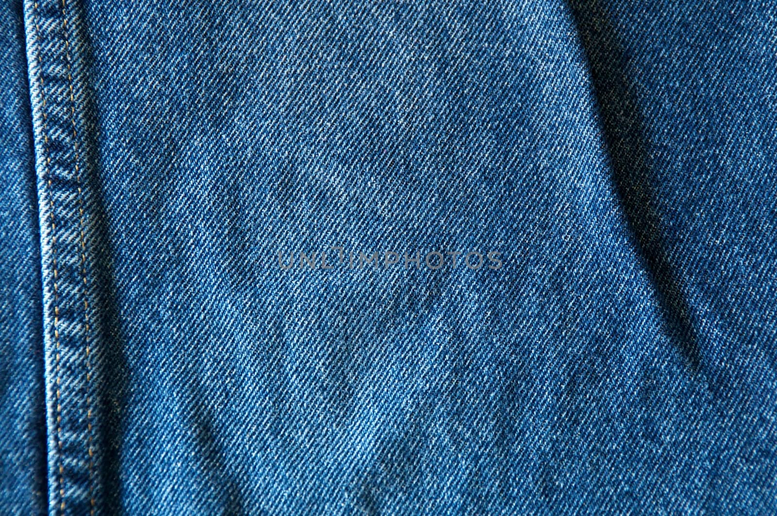 Close up of blue denim showing double seam.