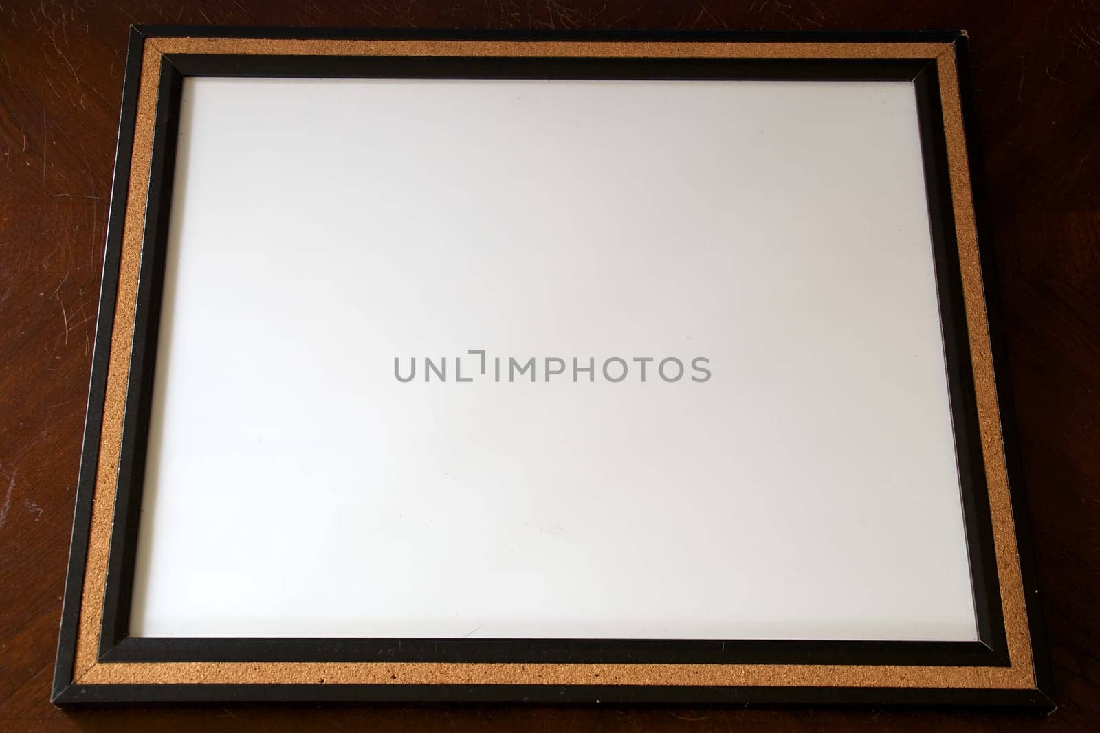 A blank white board surrounded with cork.