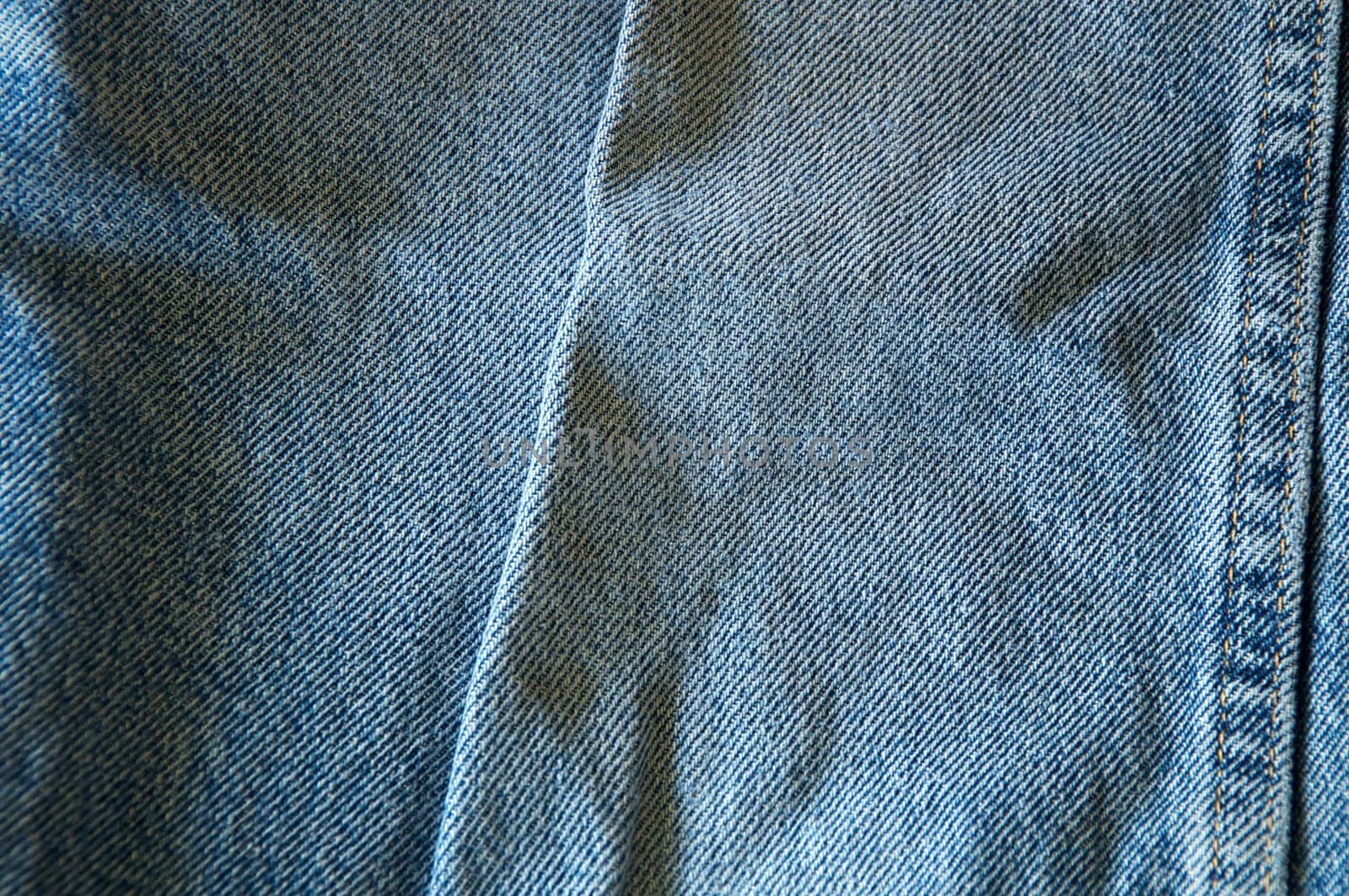 Close up of blue denim showing double seam.