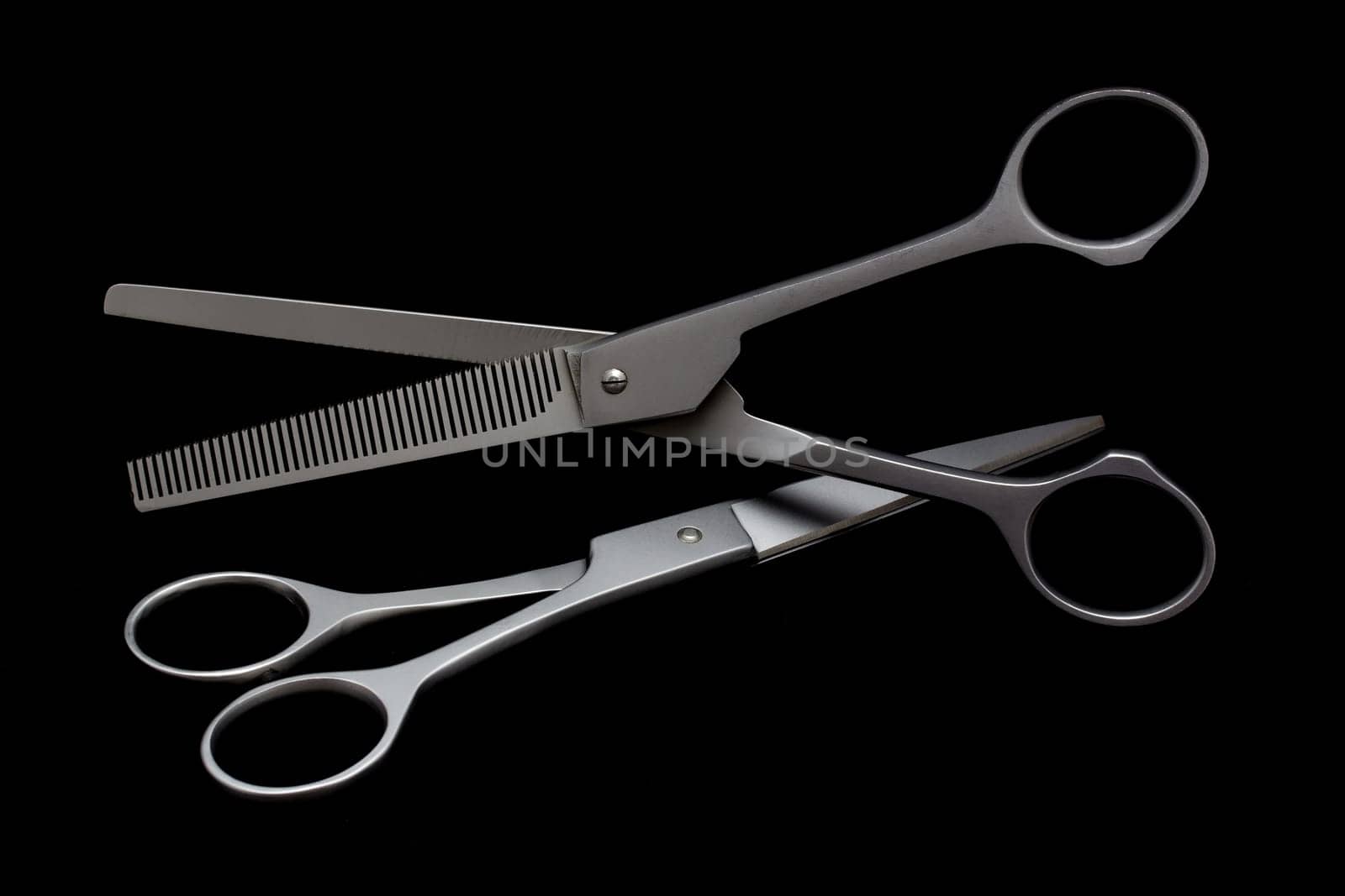 Dog grooming scissors on the black background