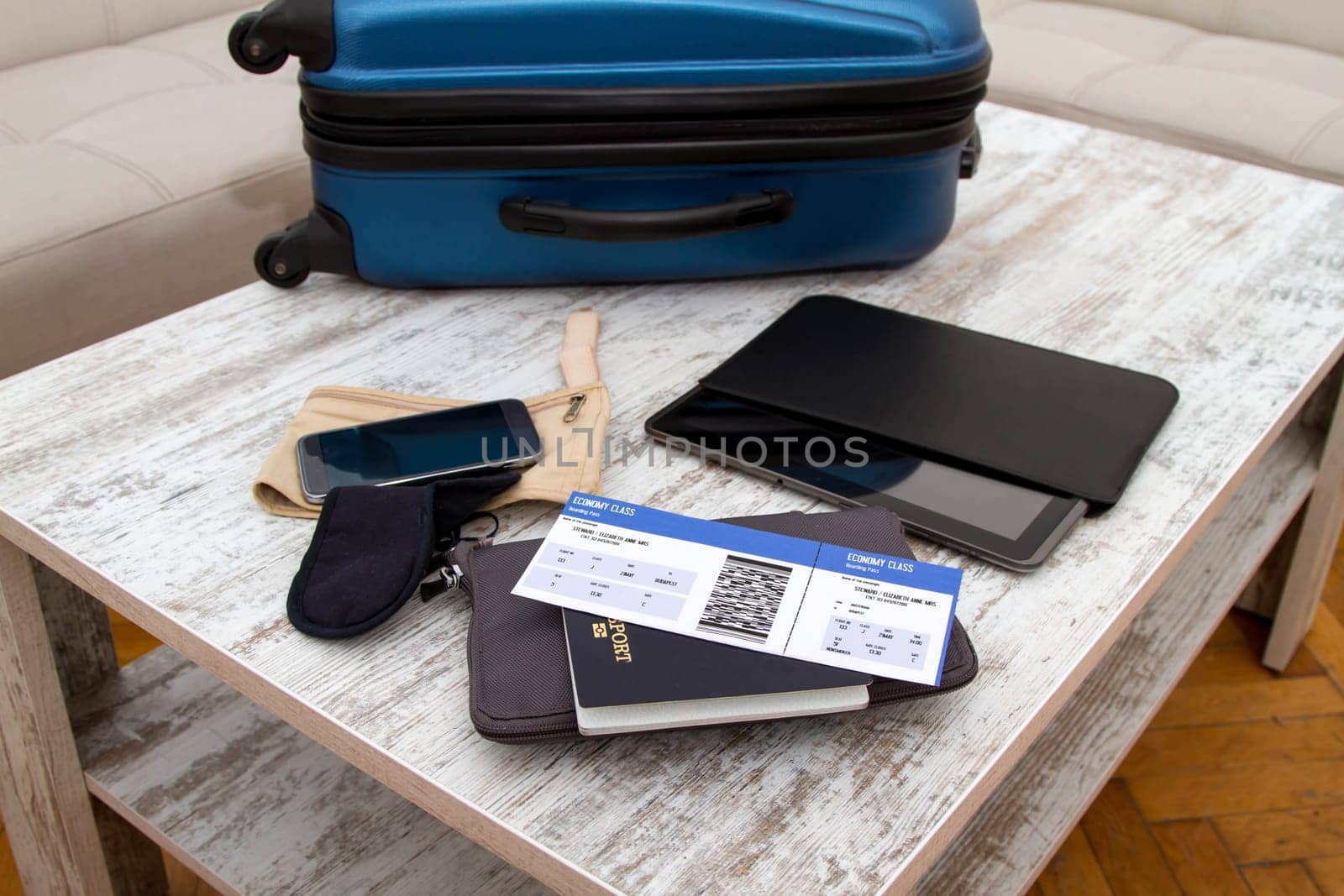 Airline ticket, passport and luggage, ready to travel.