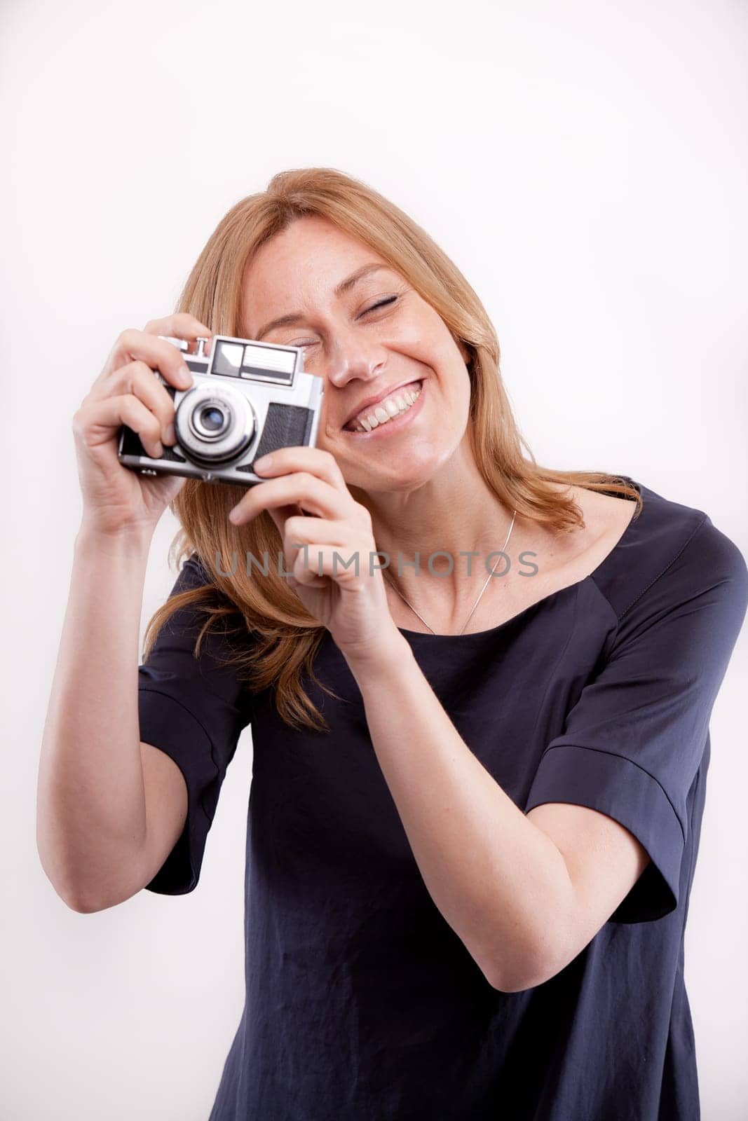 smiling real woman taking shootings with her camera