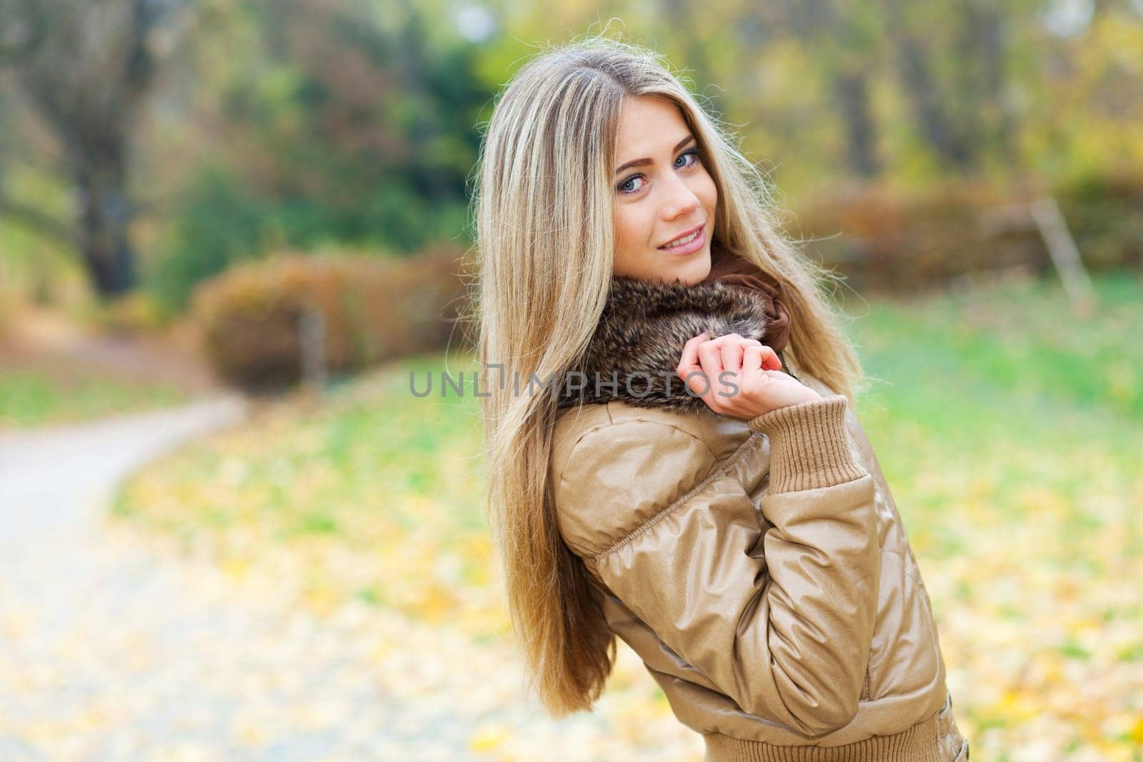 Beautiful woman walking in a park in autumn