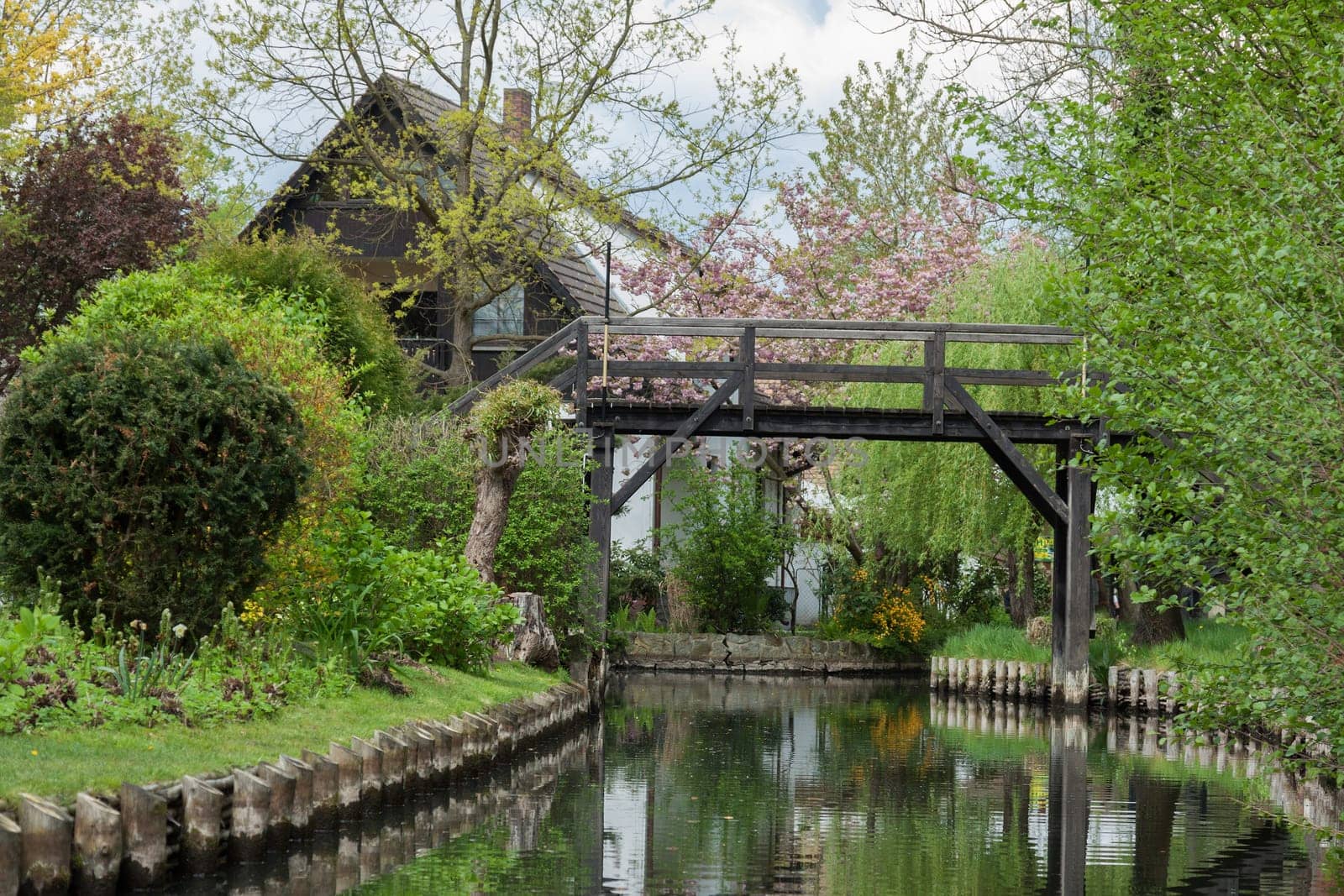 Small wooden bridge leads over a canal in the Spreewald