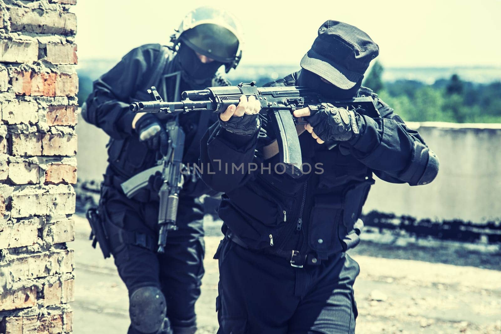 Two spec ops soldiers in black uniform in action