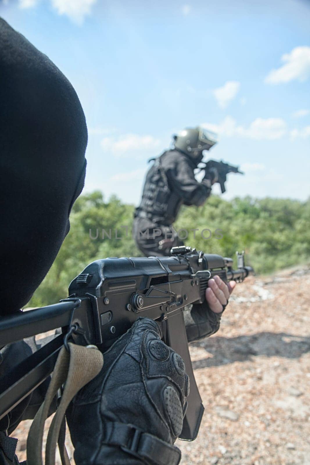 Two spec ops soldiers in black uniform in action