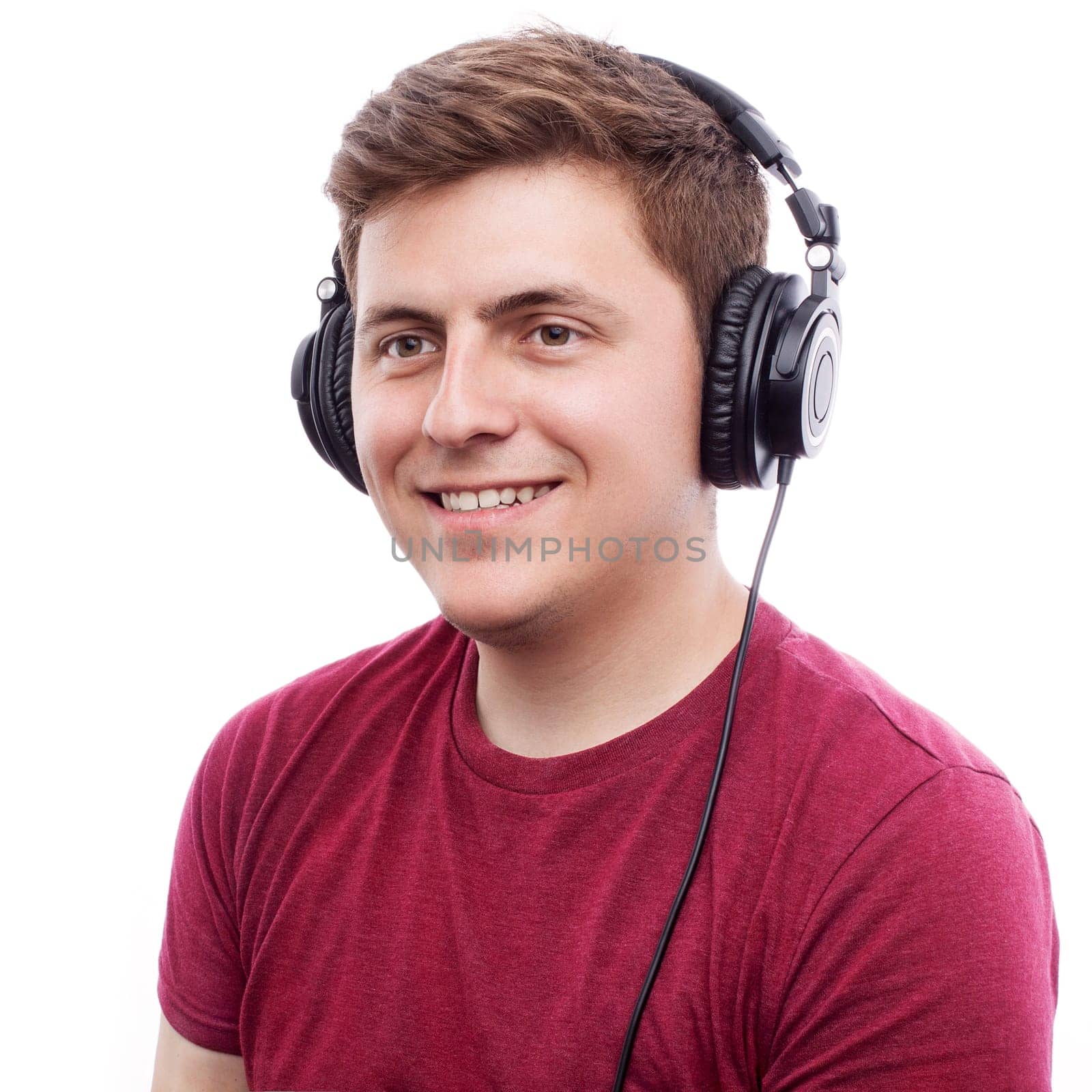 Young happy man listening something on headphones