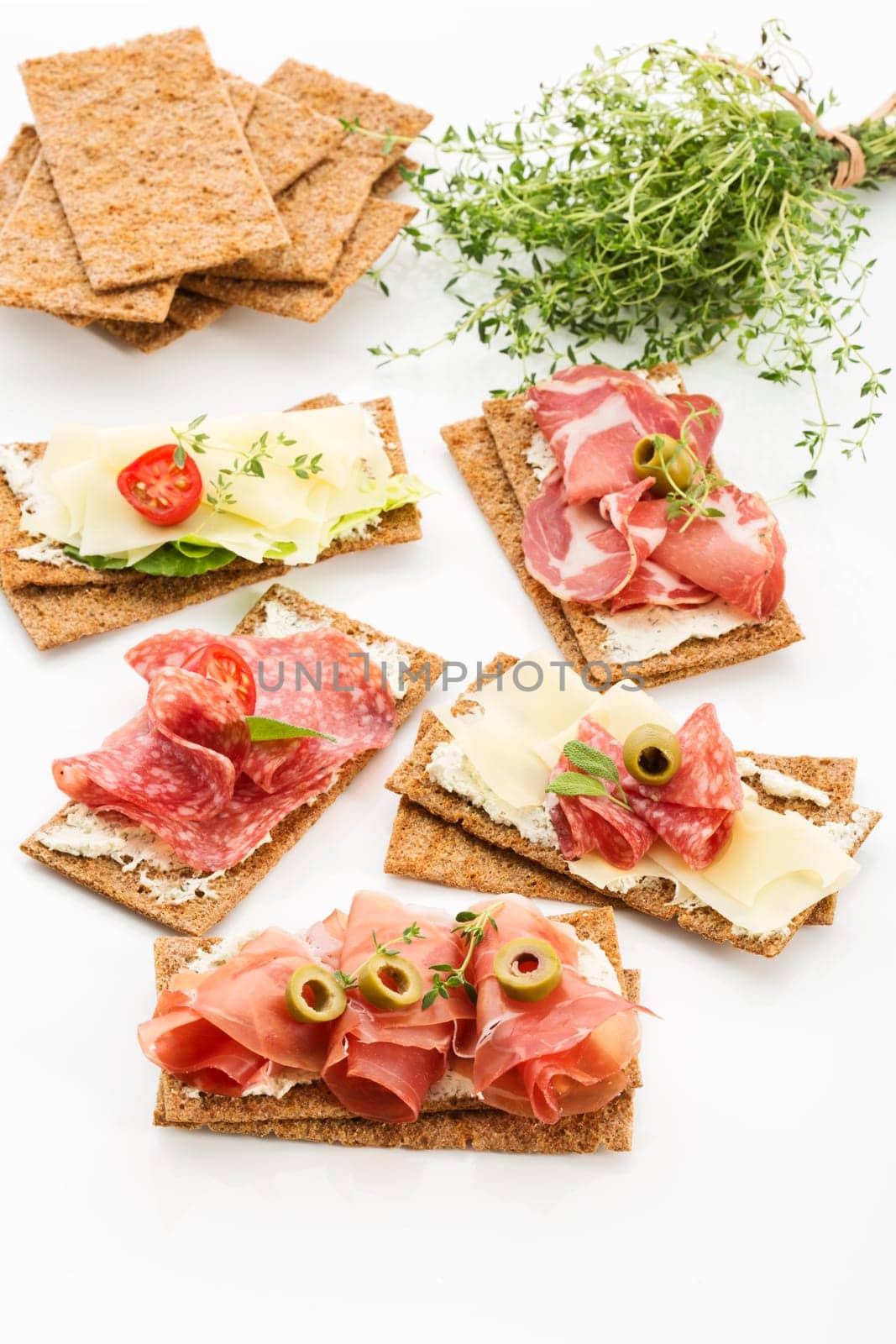 Finnish rye crispbread with salami Milano,Coppa ham,Prosciutto Crudo,Emmentaler,cream cheese with Herbs of Provence and Olive