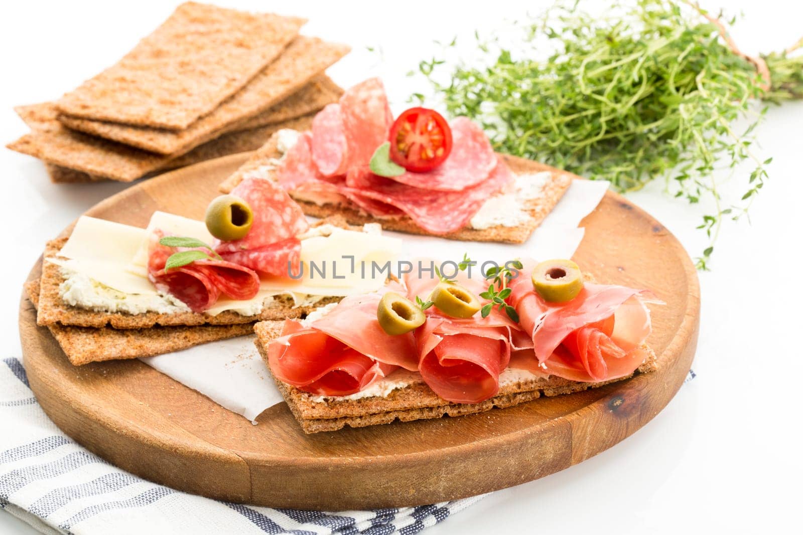 Finnish rye crispbread with salami Milano,Coppa ham,Prosciutto Crudo,Emmentaler,cream cheese with Herbs of Provence and Olive