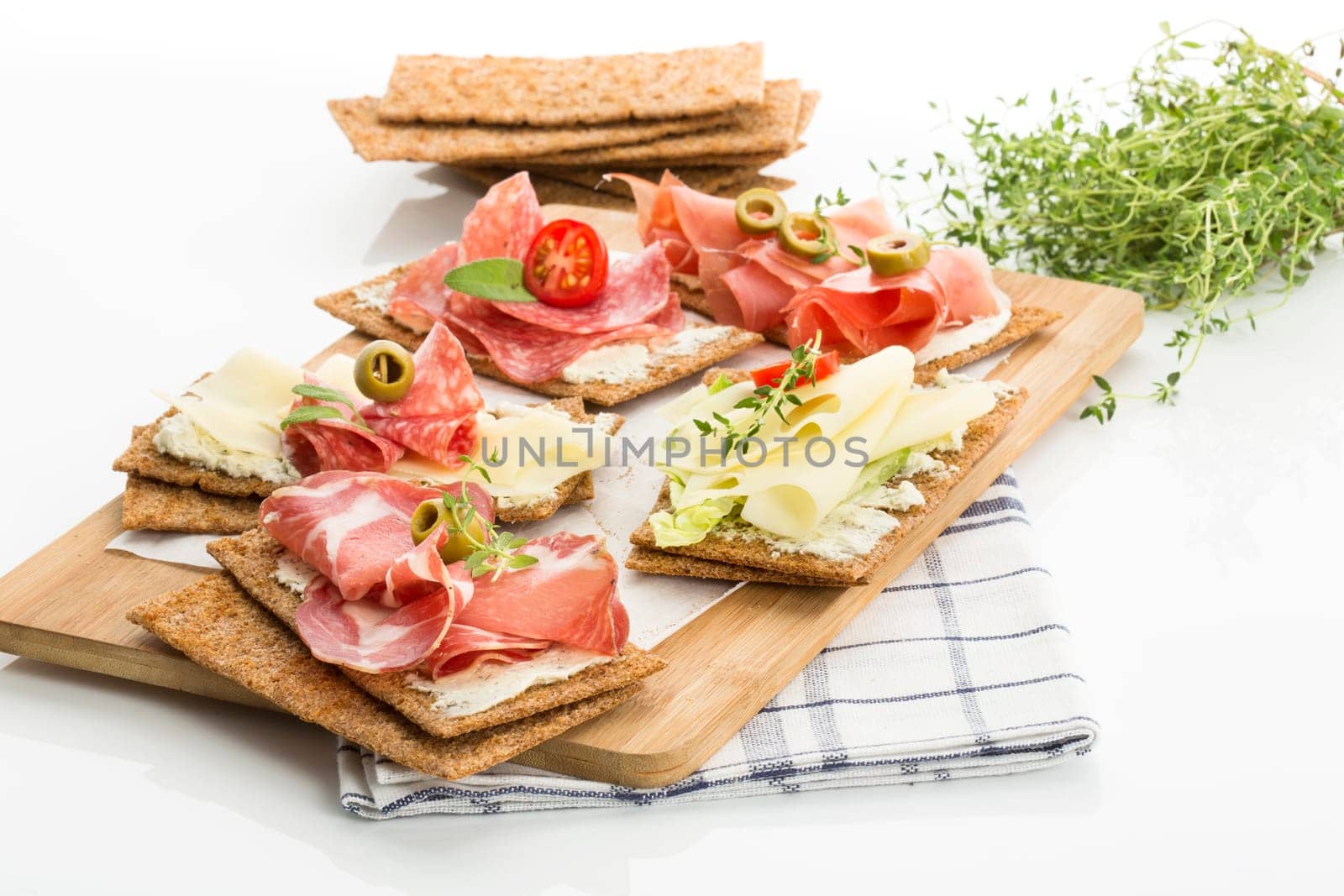 Finnish rye crispbread with salami Milano,Coppa ham,Prosciutto Crudo,Emmentaler,cream cheese with Herbs of Provence and Olive