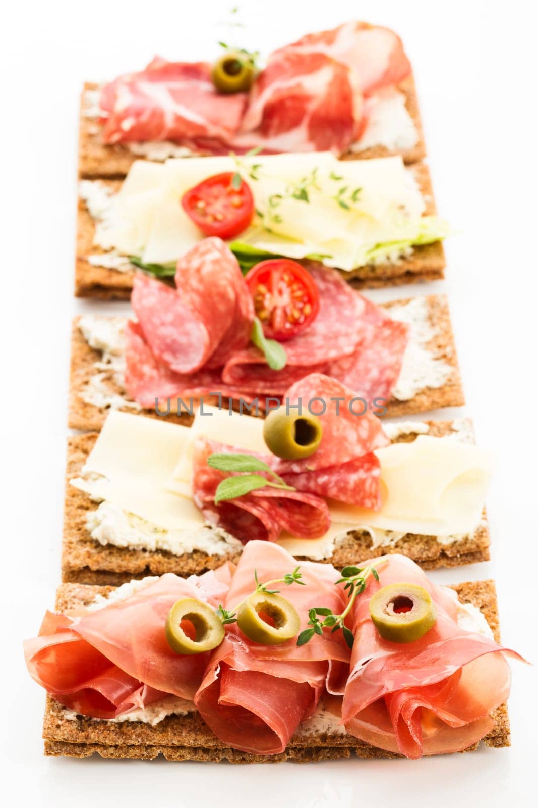 Finnish rye crispbread with salami Milano,Coppa ham,Prosciutto Crudo,Emmentaler,cream cheese with Herbs of Provence and Olive