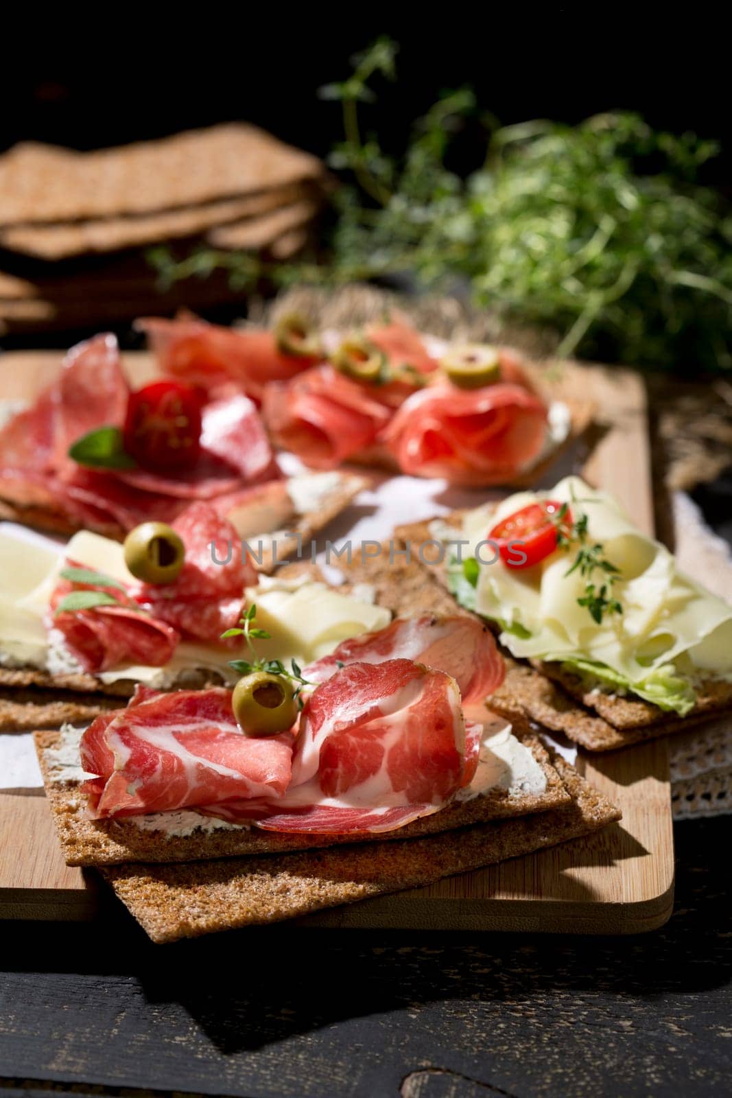 Finnish rye crispbread with salami Milano,Coppa ham,Prosciutto Crudo,Emmentaler,cream cheese with Herbs of Provence and Olive