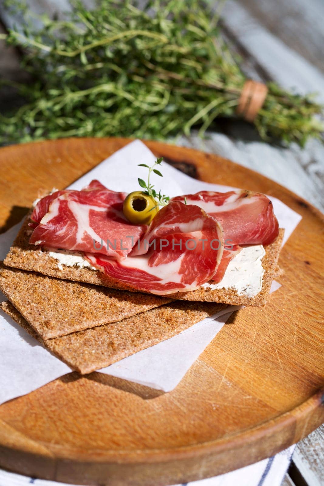 Finnish rye crispbread with salami Milano,Coppa ham,Prosciutto Crudo,Emmentaler,cream cheese with Herbs of Provence and Olive