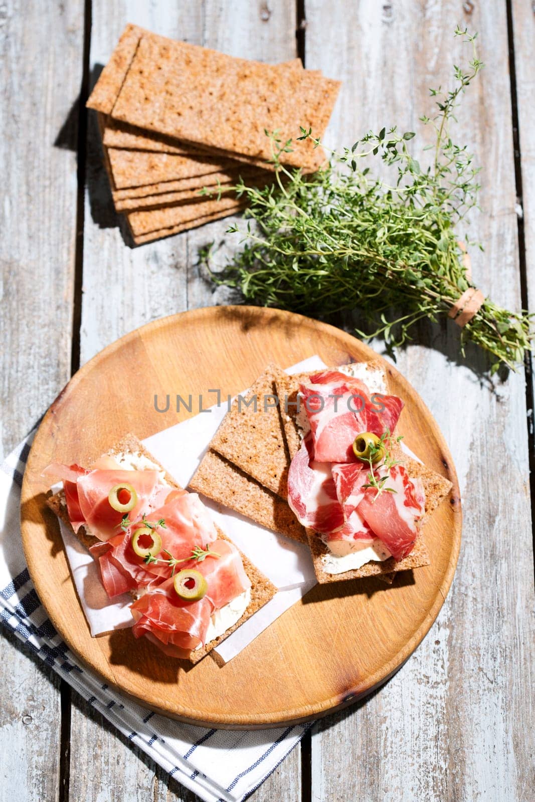 Finnish rye crispbread with salami Milano,Coppa ham,Prosciutto Crudo,Emmentaler,cream cheese with Herbs of Provence and Olive