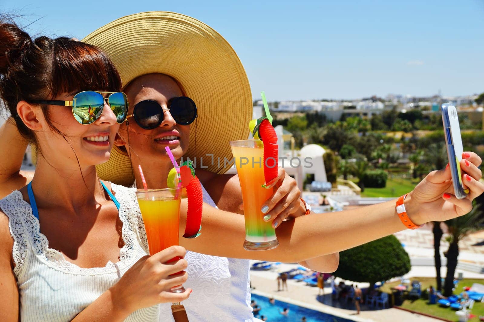 Two young women taking picture of themselves on vacation.