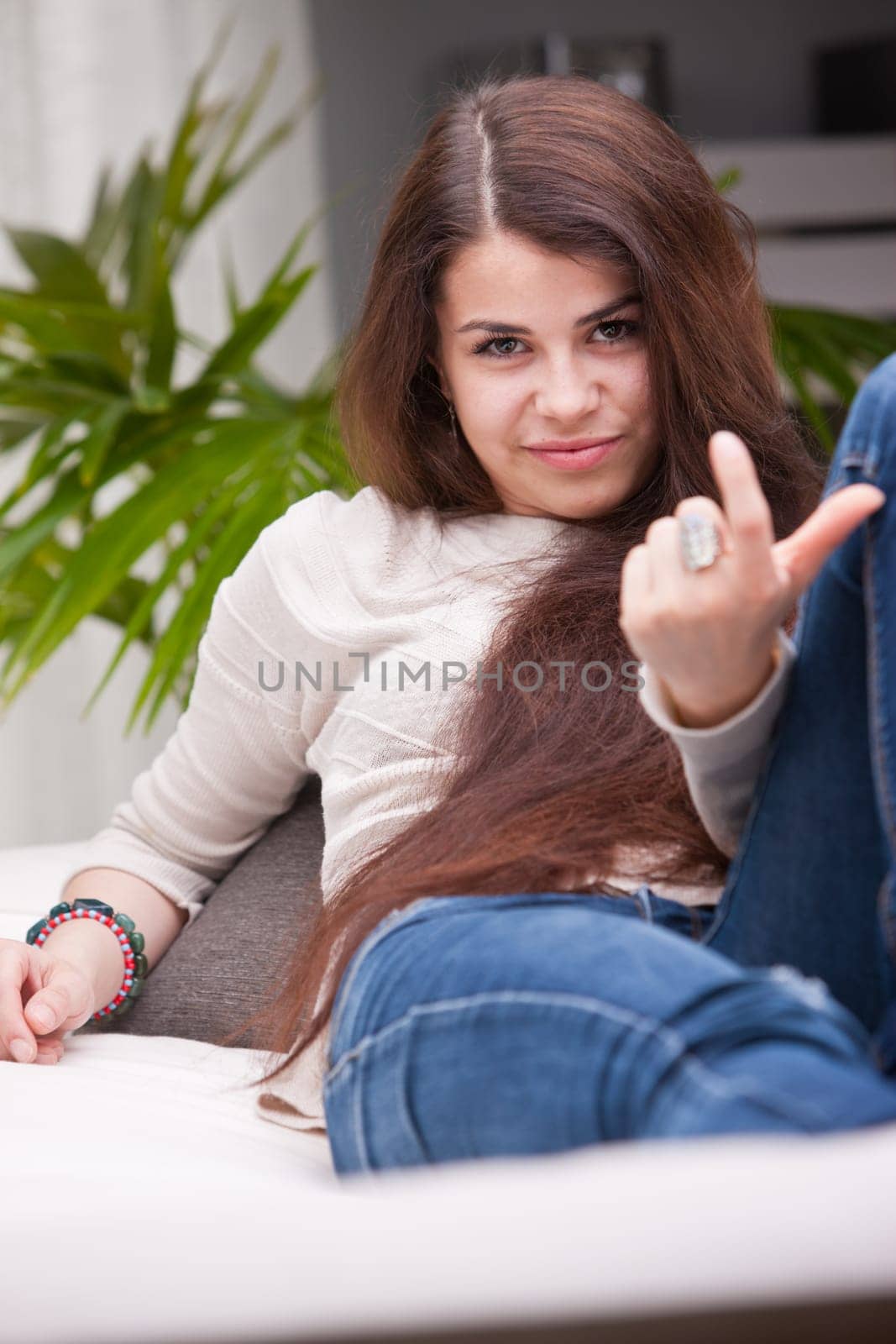 young girl calling someone with a gesture that says come here and let's see