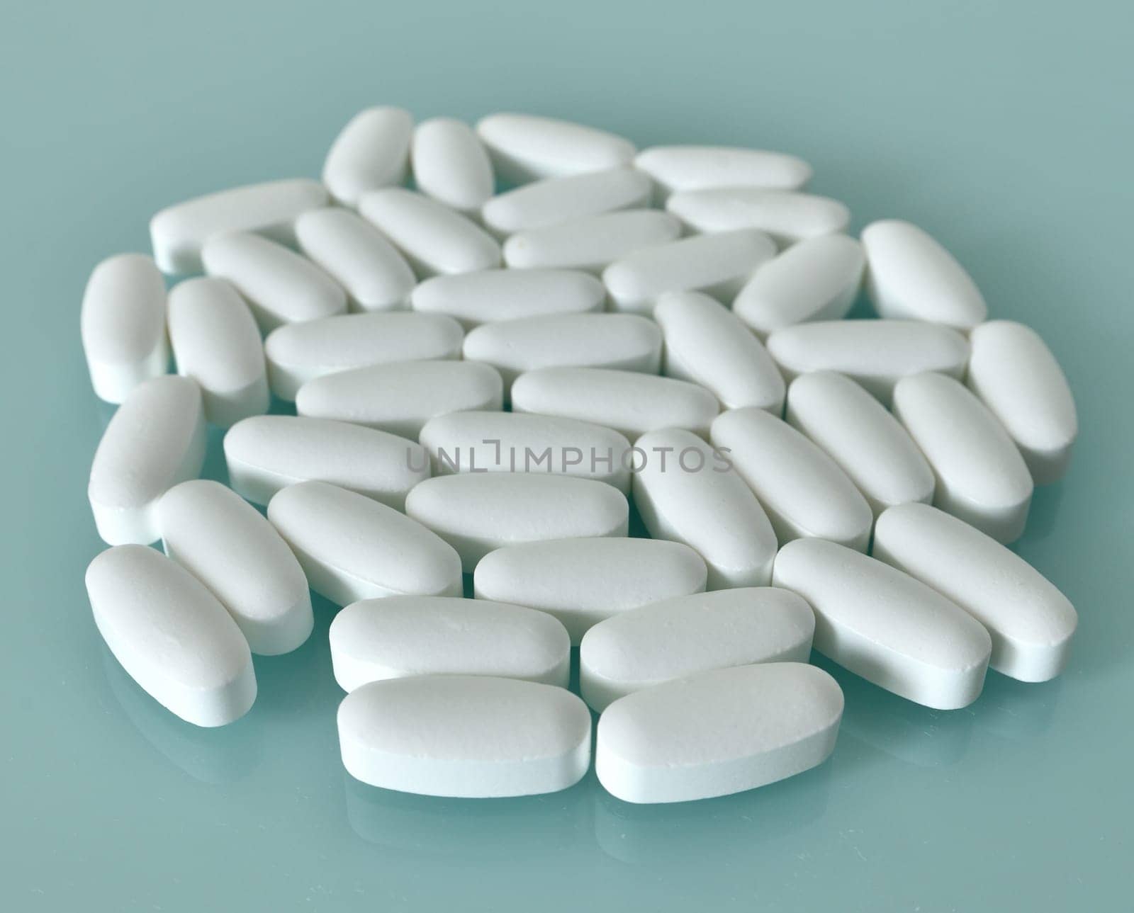 White large pills on blue background